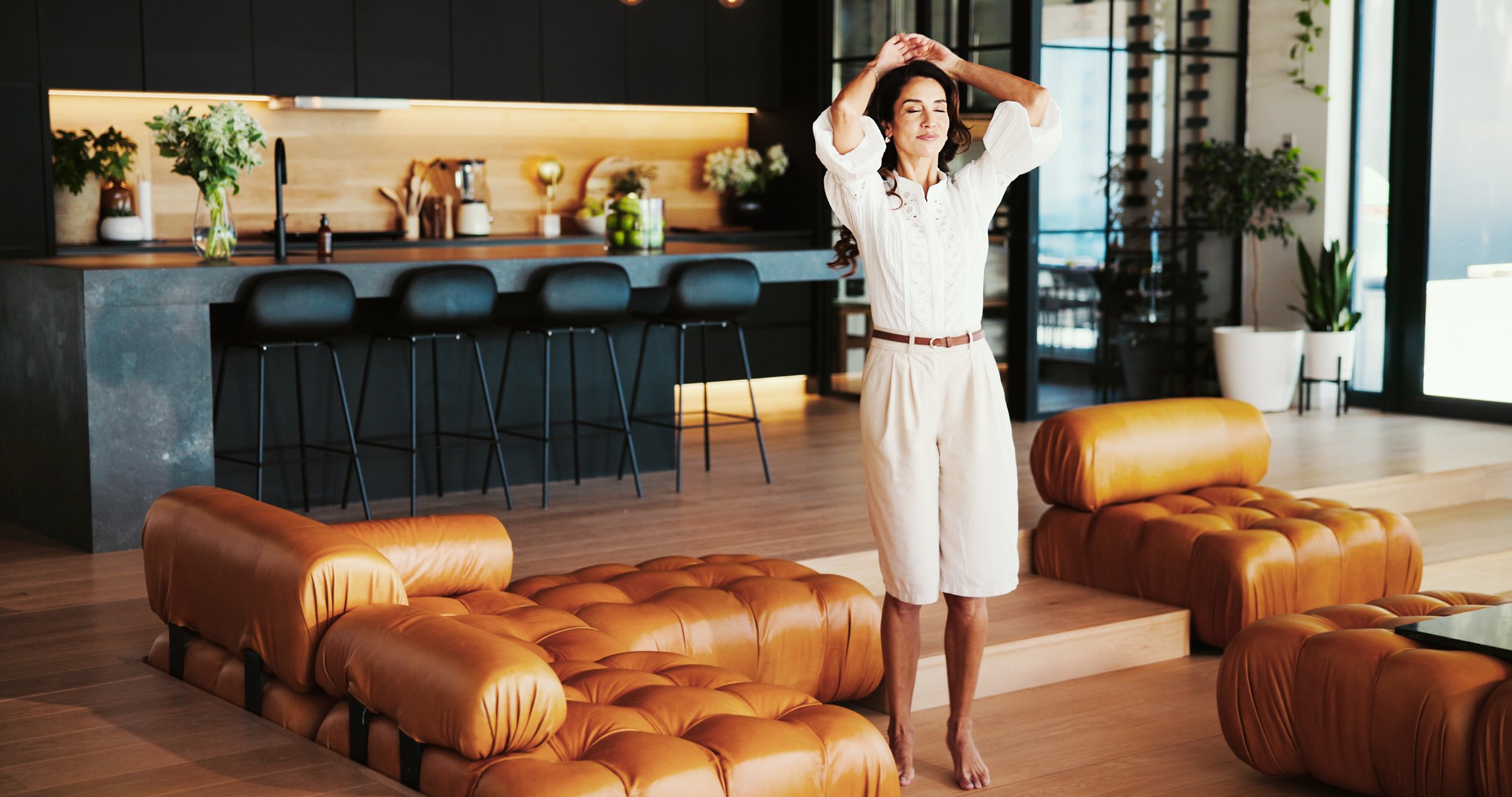 Relax, breathing and woman in home on break for inspiration in living room in luxury hotel. Reflection, vacation and calm person stretching in lounge for peaceful weekend getaway in holiday house