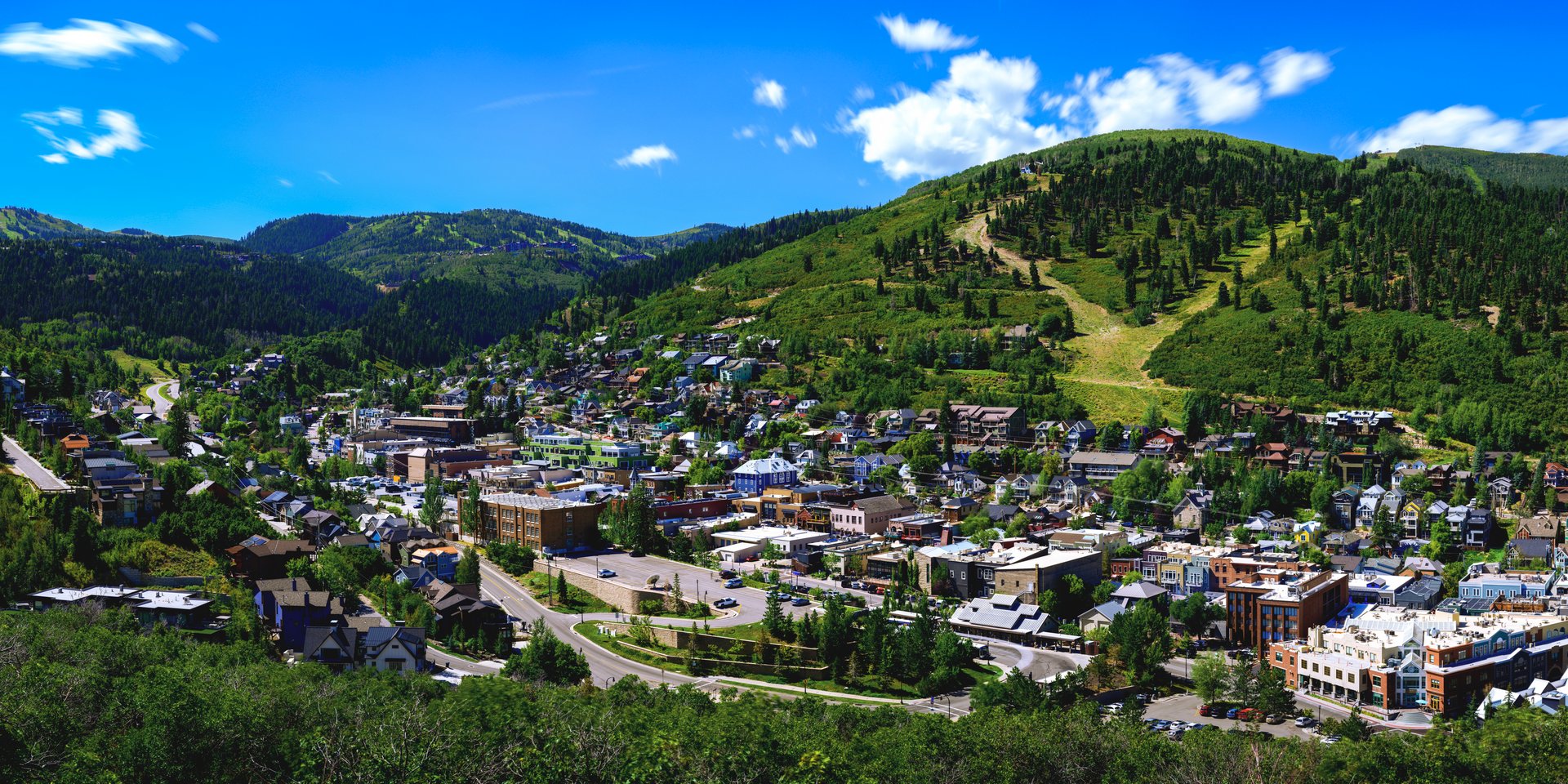 Park City Mountain Ski Resort and historic downtown summer landscape with landmark buildings in Utah, panoramic scenery with green trees of the Wasatch Mountains