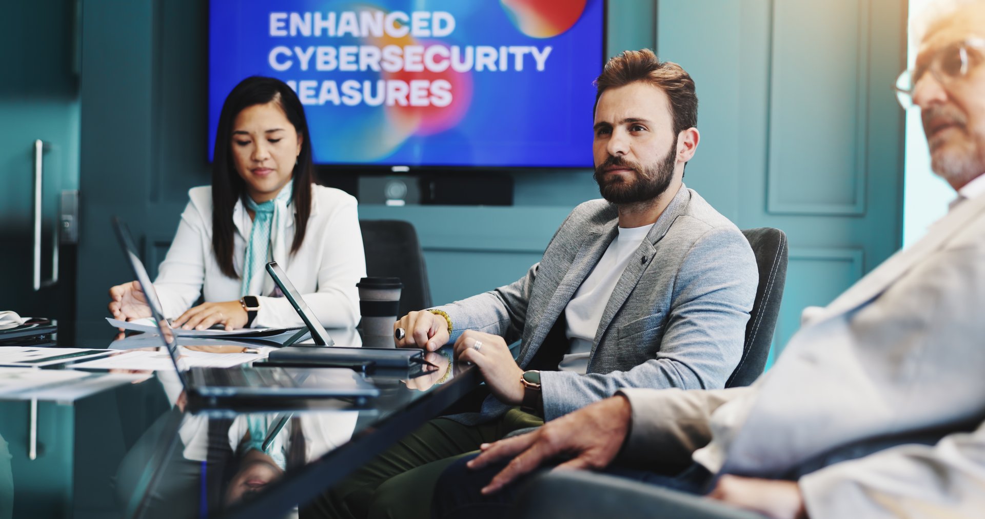 Meeting, laptop and business people in office with screen for enhanced cybersecurity measures. Discussion, teamwork and investors with computer for investment proposal on data protection service.