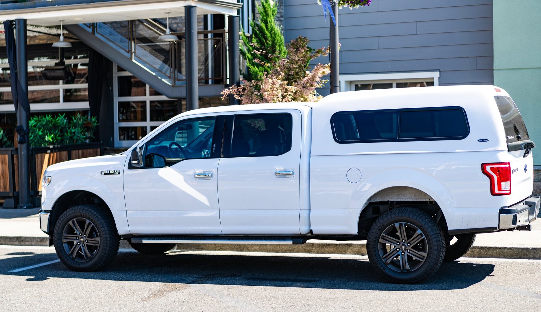 Seattle, USA - July 14, 2024: Ford F150 light truck parked outdoor, side view. Ford F150 in the street. Truck of Ford F150.