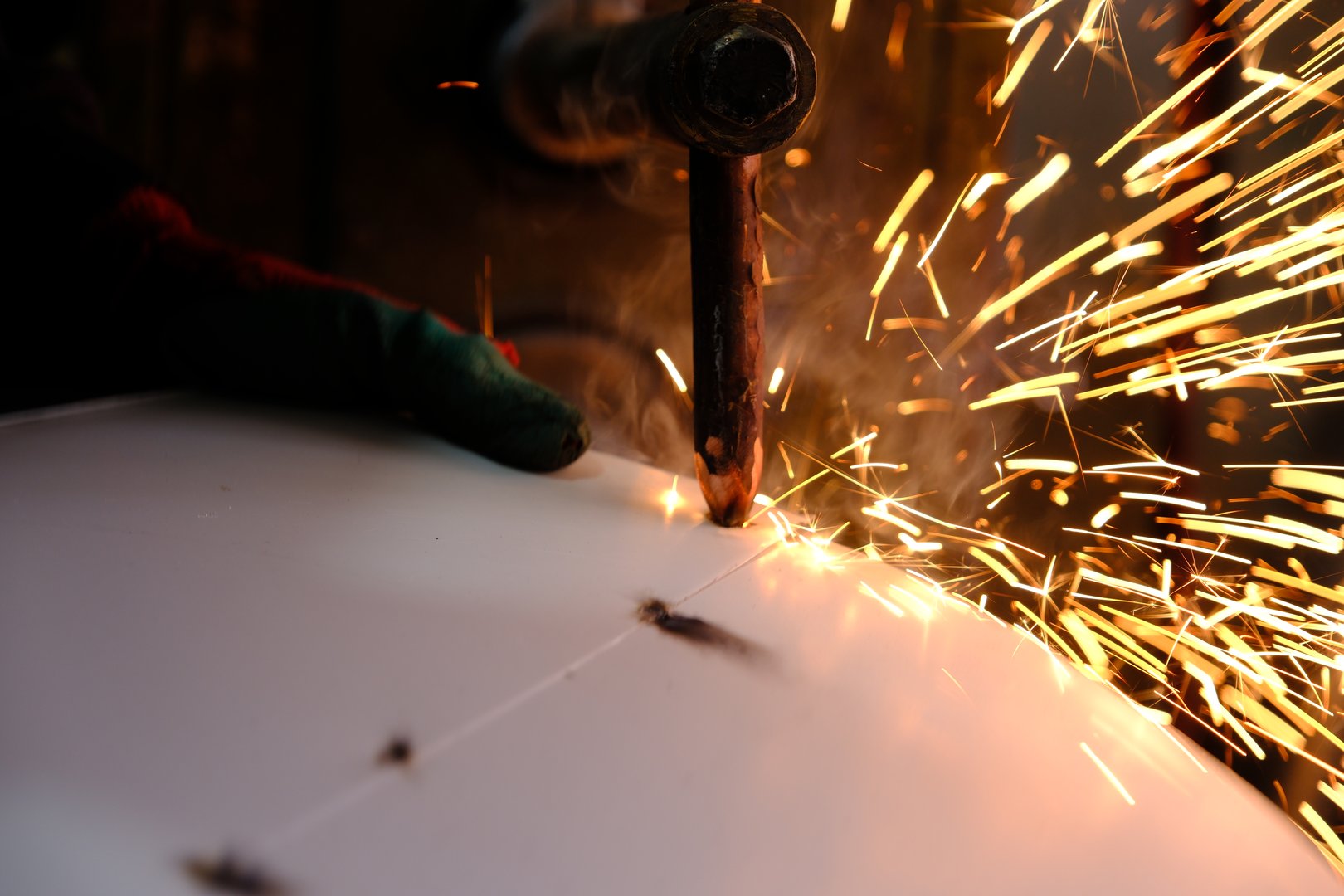 a master who welds sheet metal with spot welding