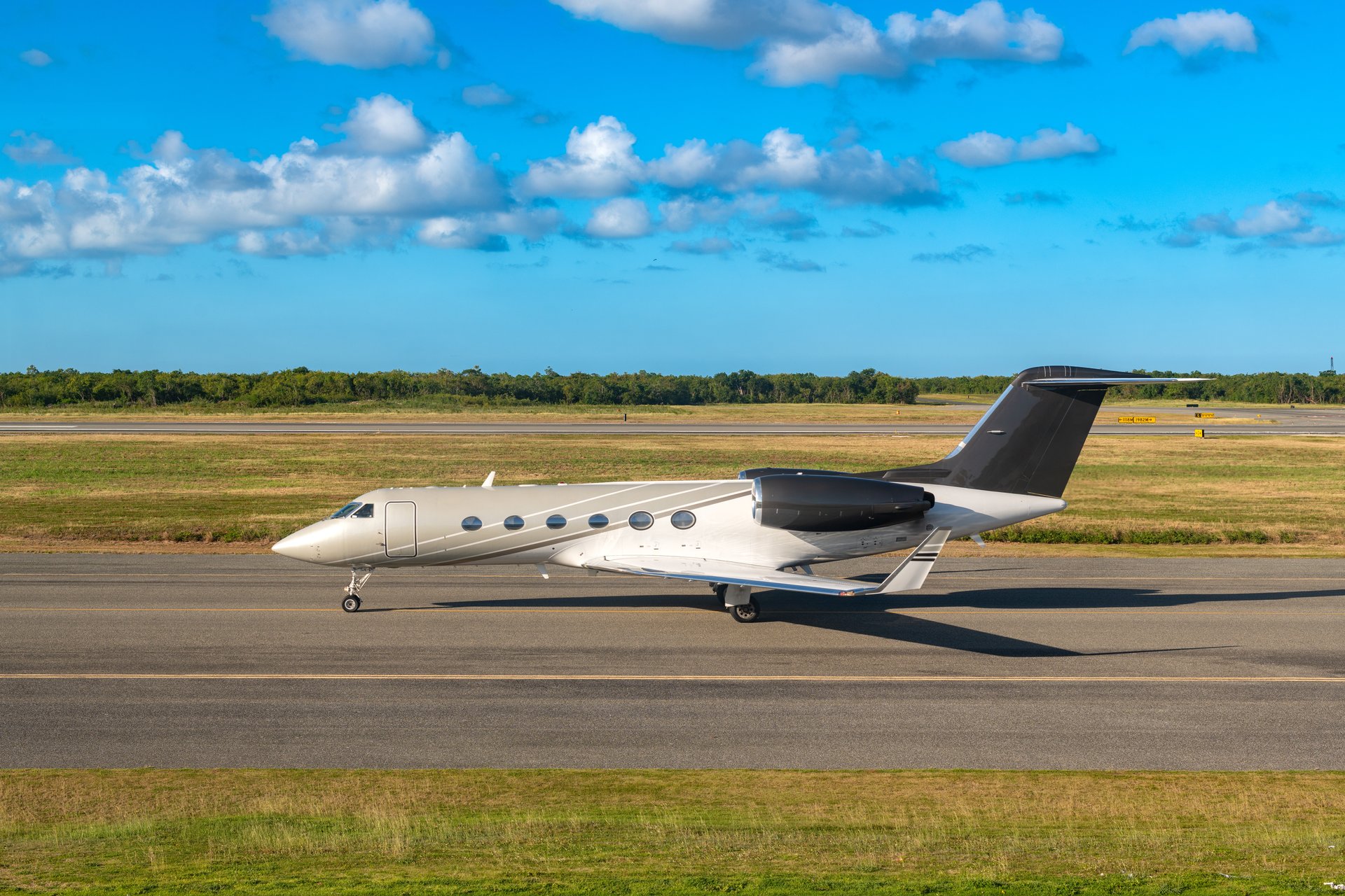 A sleek private jet is taxiing on the runway of Punta Cana airport.