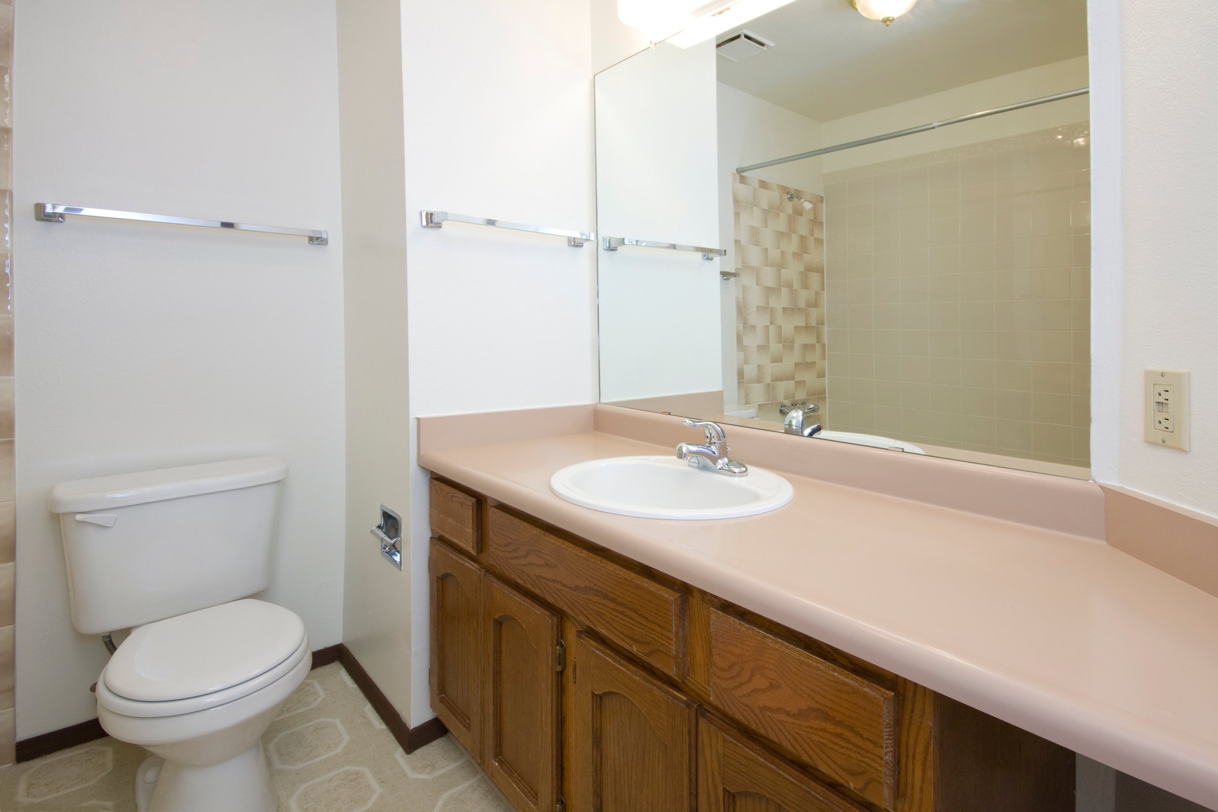 2000s bathroom with builder grade fixtures outdated but clean
