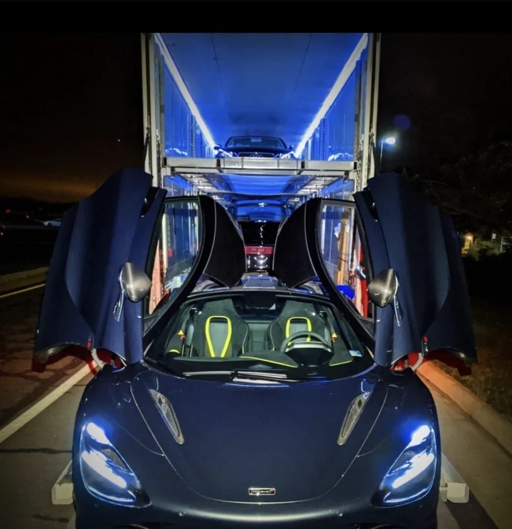Enclosed car transport trailer with luxury vehicles