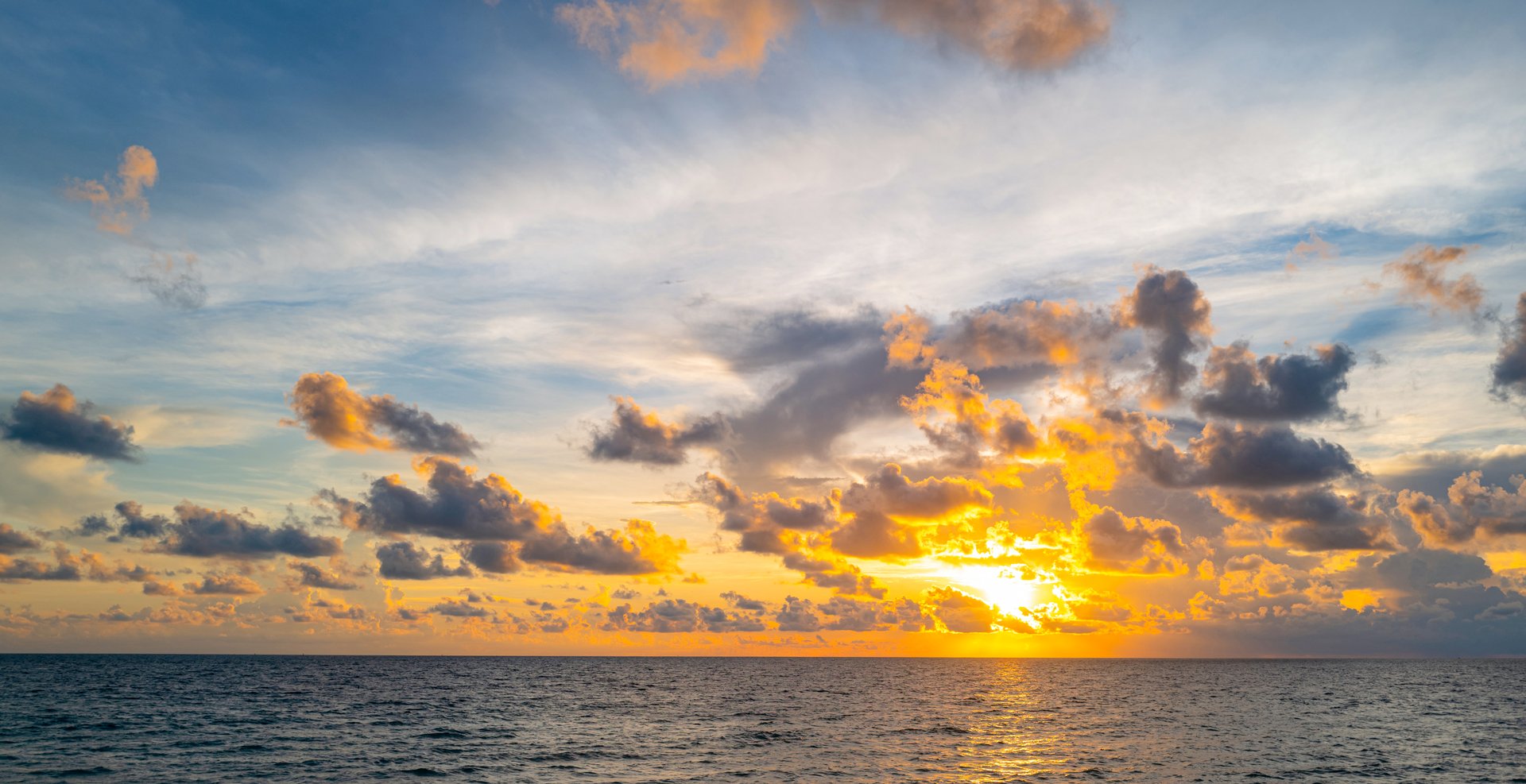 Light breaking through clouds at sunrise
