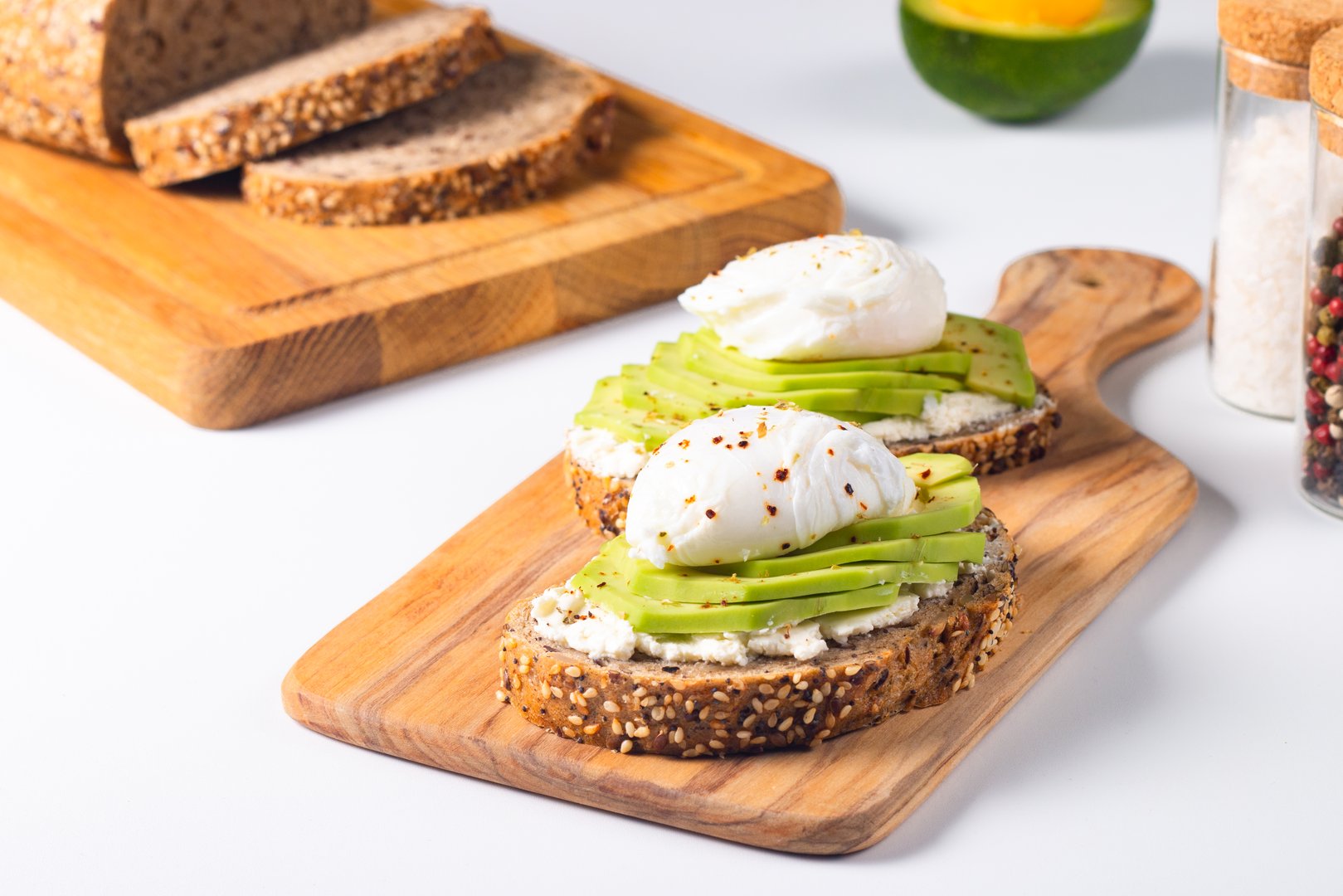 Two avocado open sandwiches with egg. Keto and diet concept. Healthy toast food for breakfast.