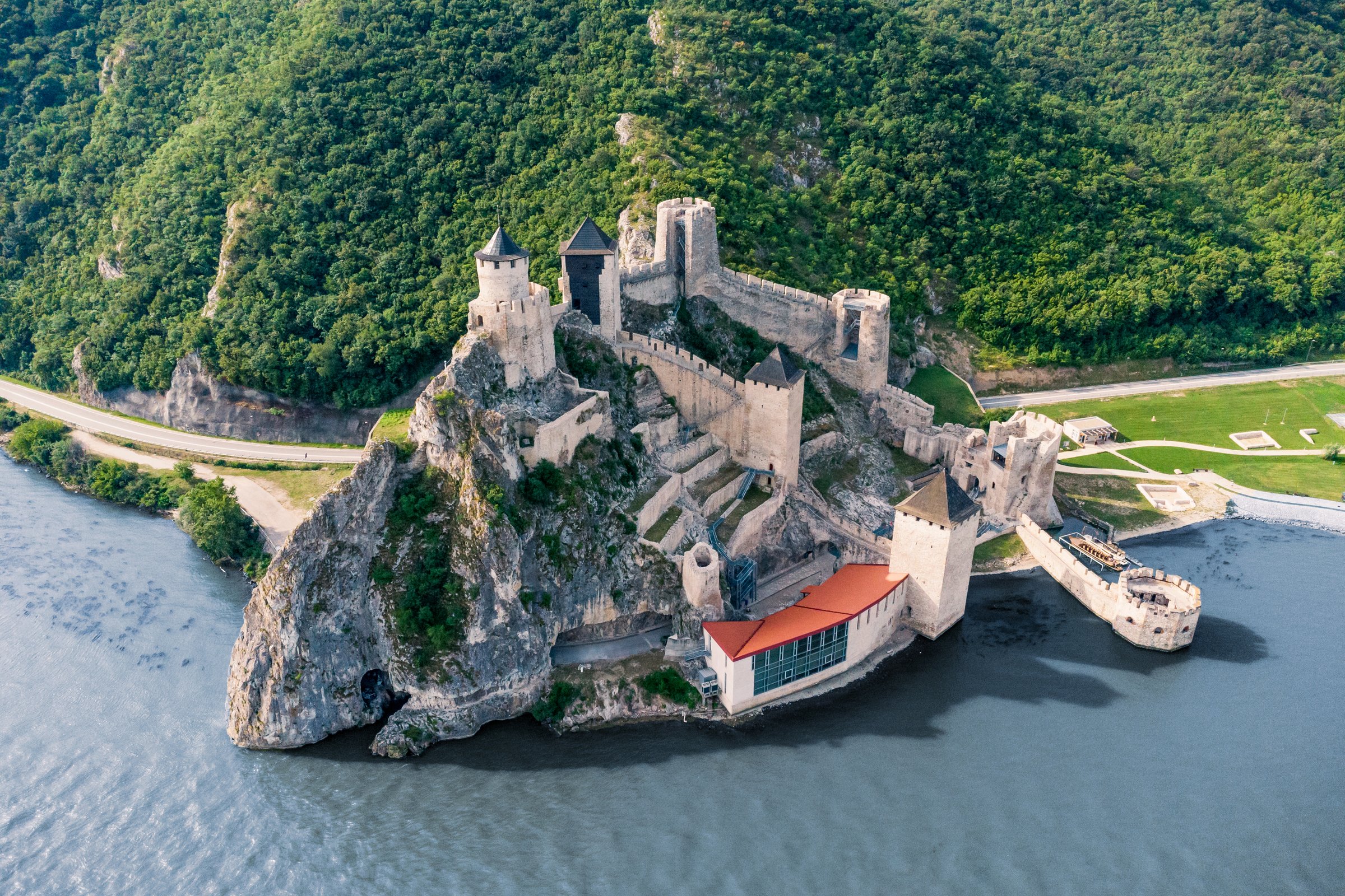 Golubac Fortress in Serbia, a historic landmark overlooking the blue Danube, captured from above on a sunny summer day.