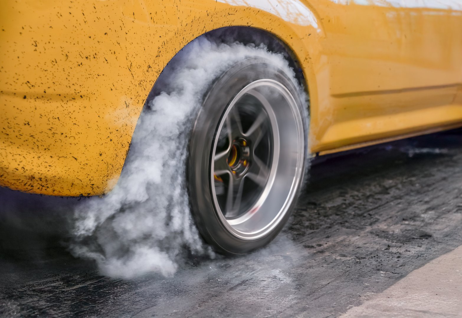 Drag racing car burns rubber off its tires in preparation for the race