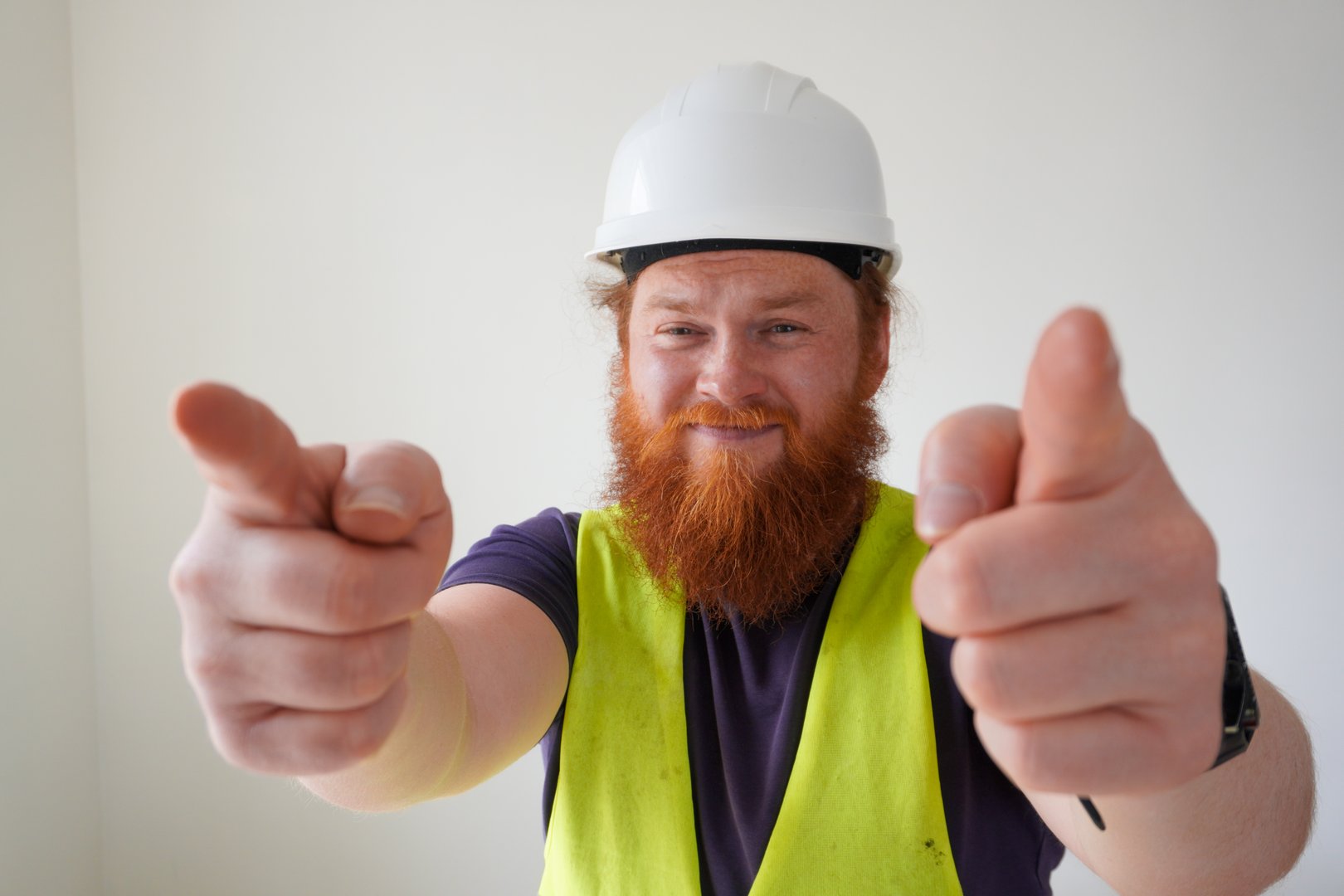 Bearded man in hard hat and safety vest