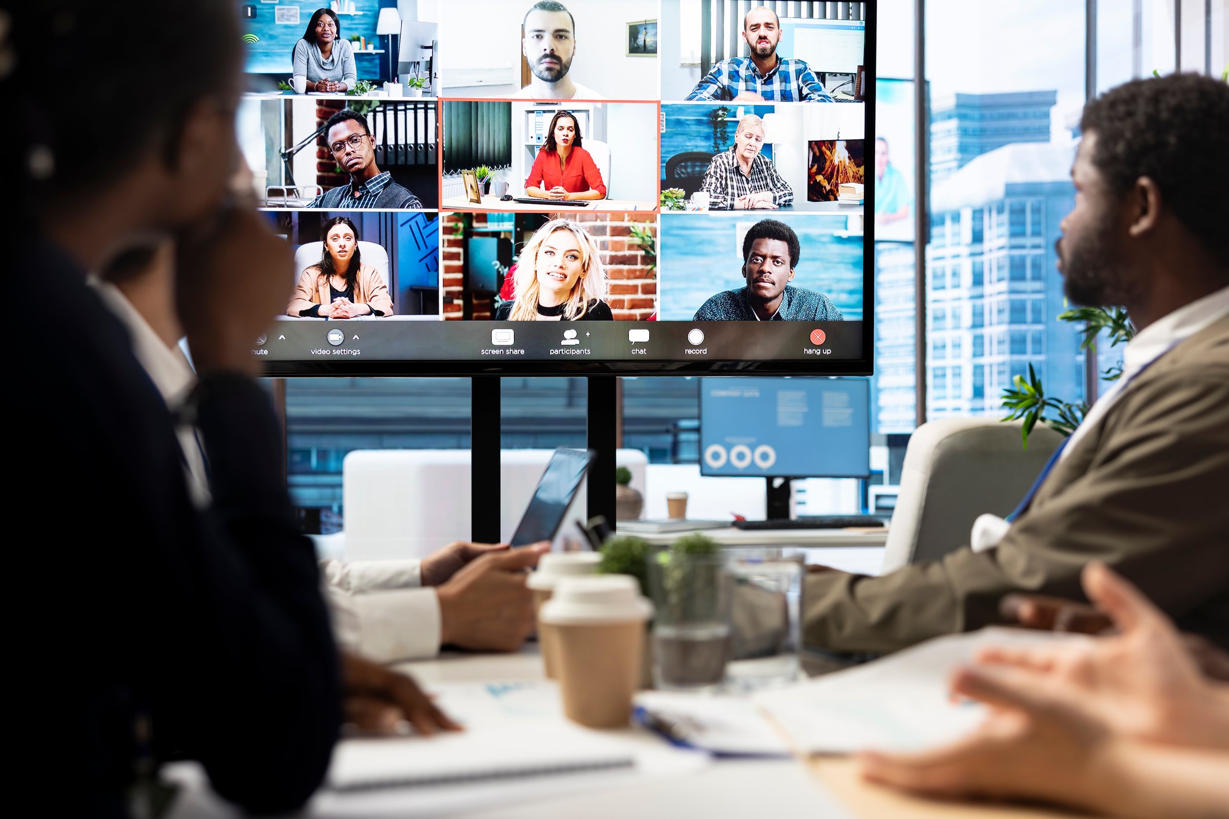 Company employees attending a meeting via videocall with investors, discussing about the future of the enterprise. Advisory board and workers examining infographics data for management.