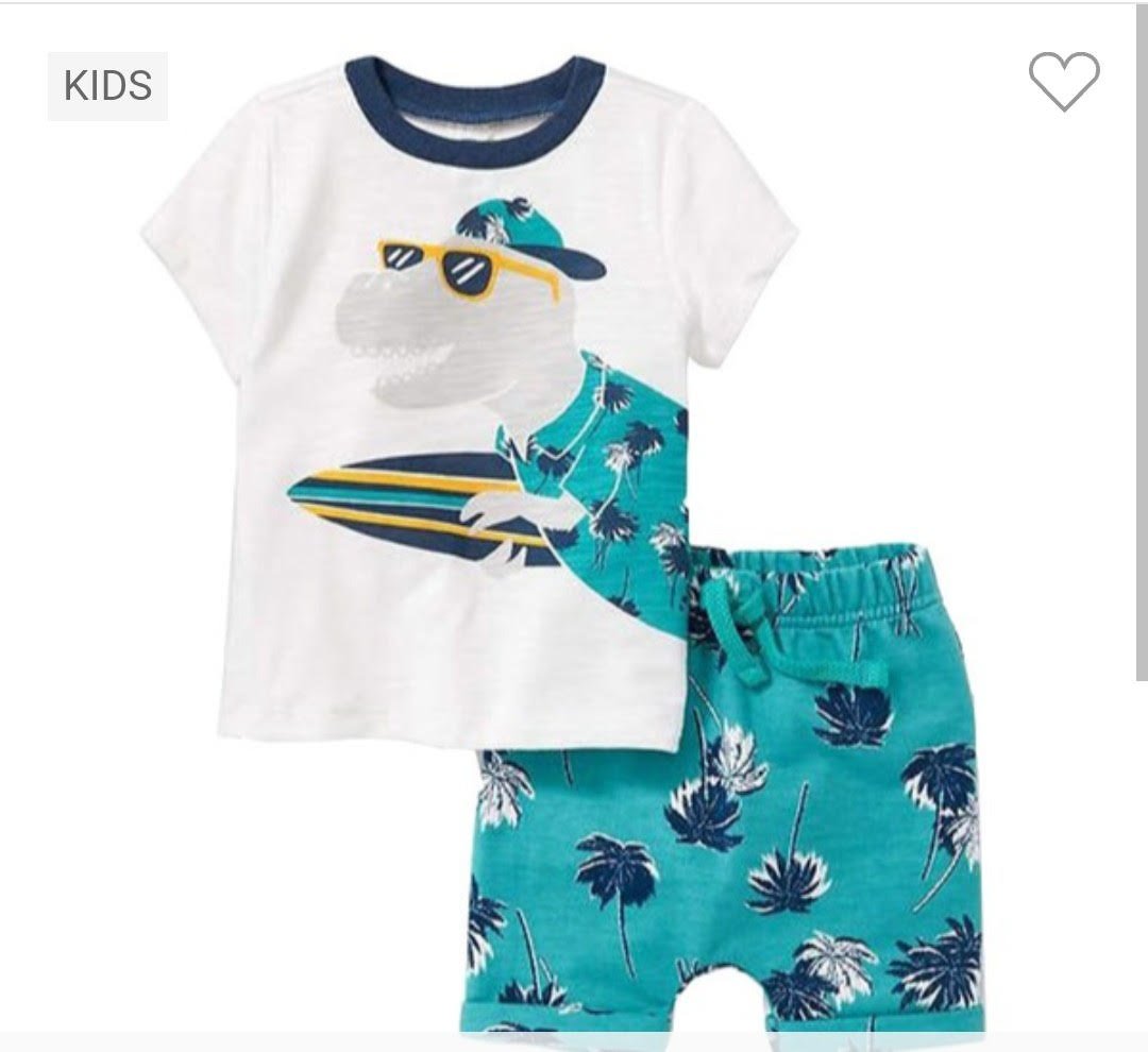 Kids summer outfit with a surfboard dinosaur motif on a white tee and blue palm tree shorts.