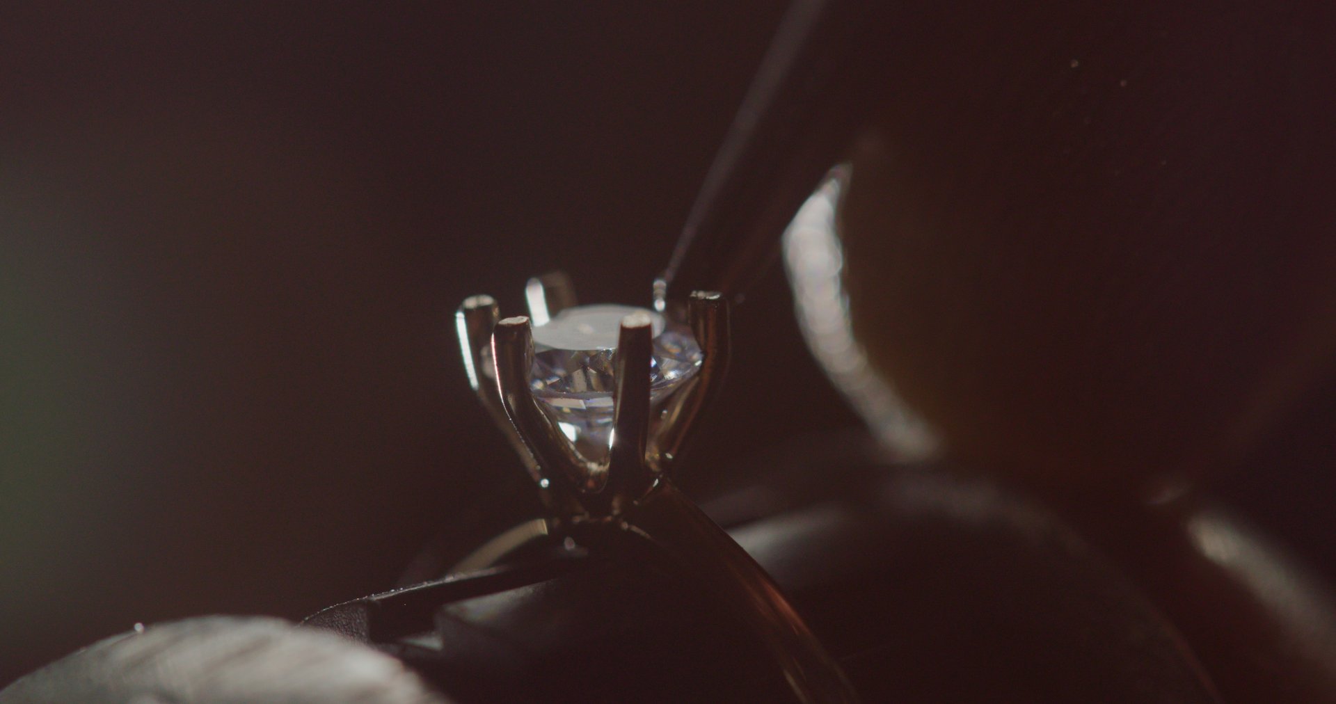 Jeweler Setting Precious Gemstone in Ring with Bright Illumination. High quality 4k footage