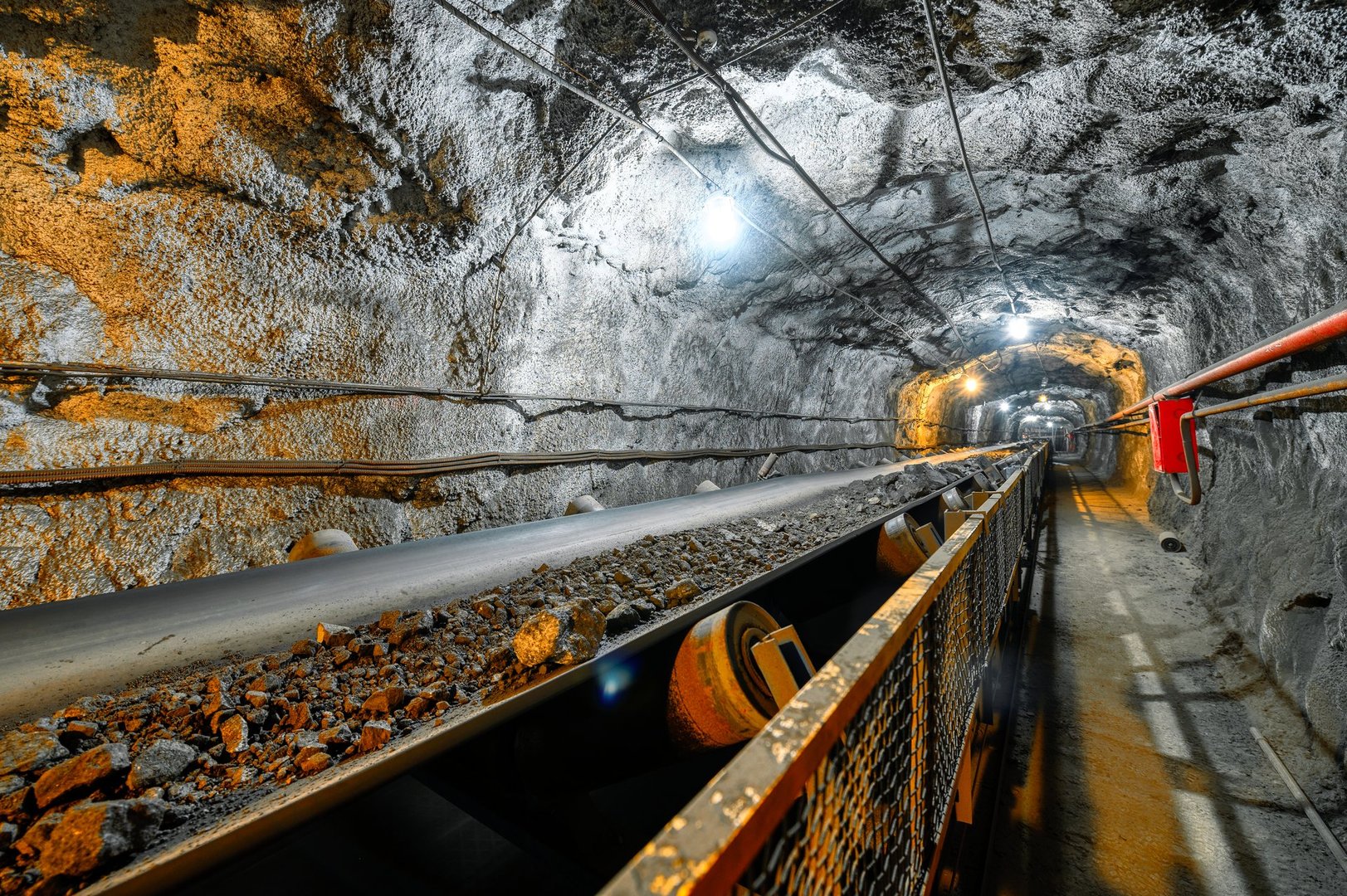 Belt conveyor in an underground tunnel. Transportation of ore to the surface.