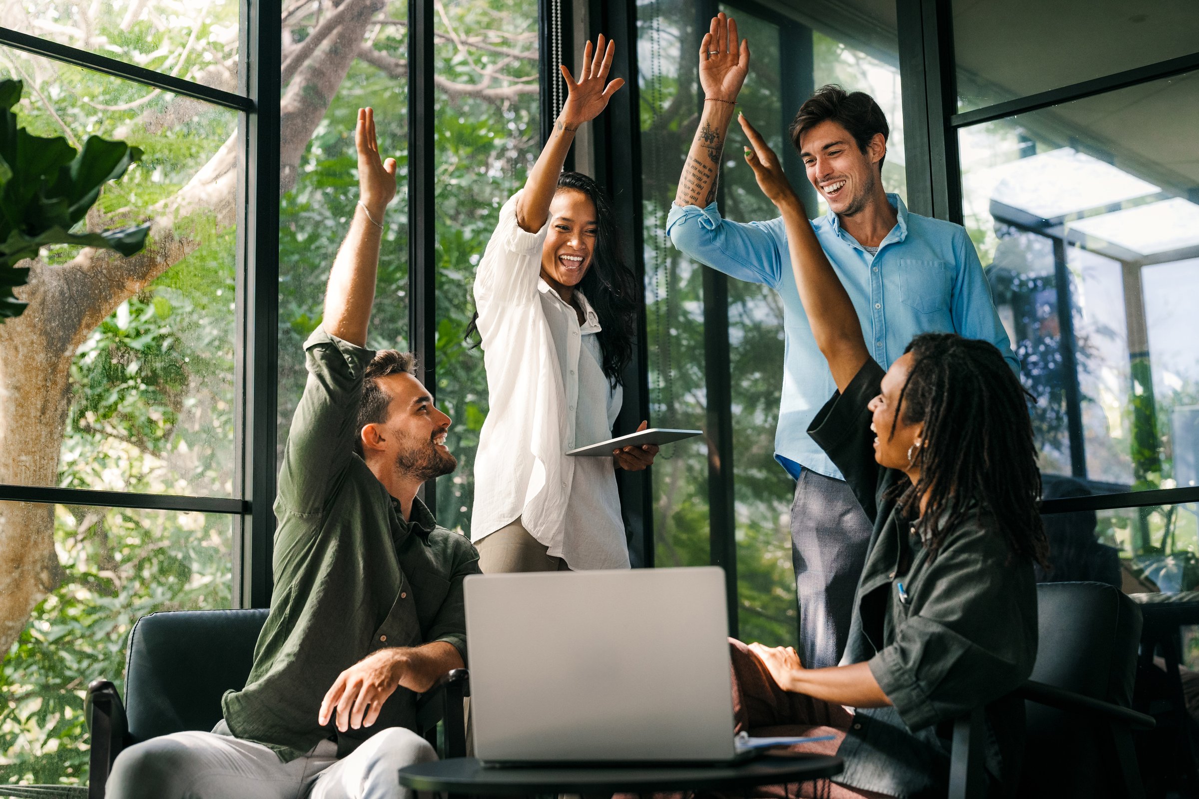 We did it again. Joyful, excited young mixed race, multiethnic entrepreneurs are celebrating their latest success