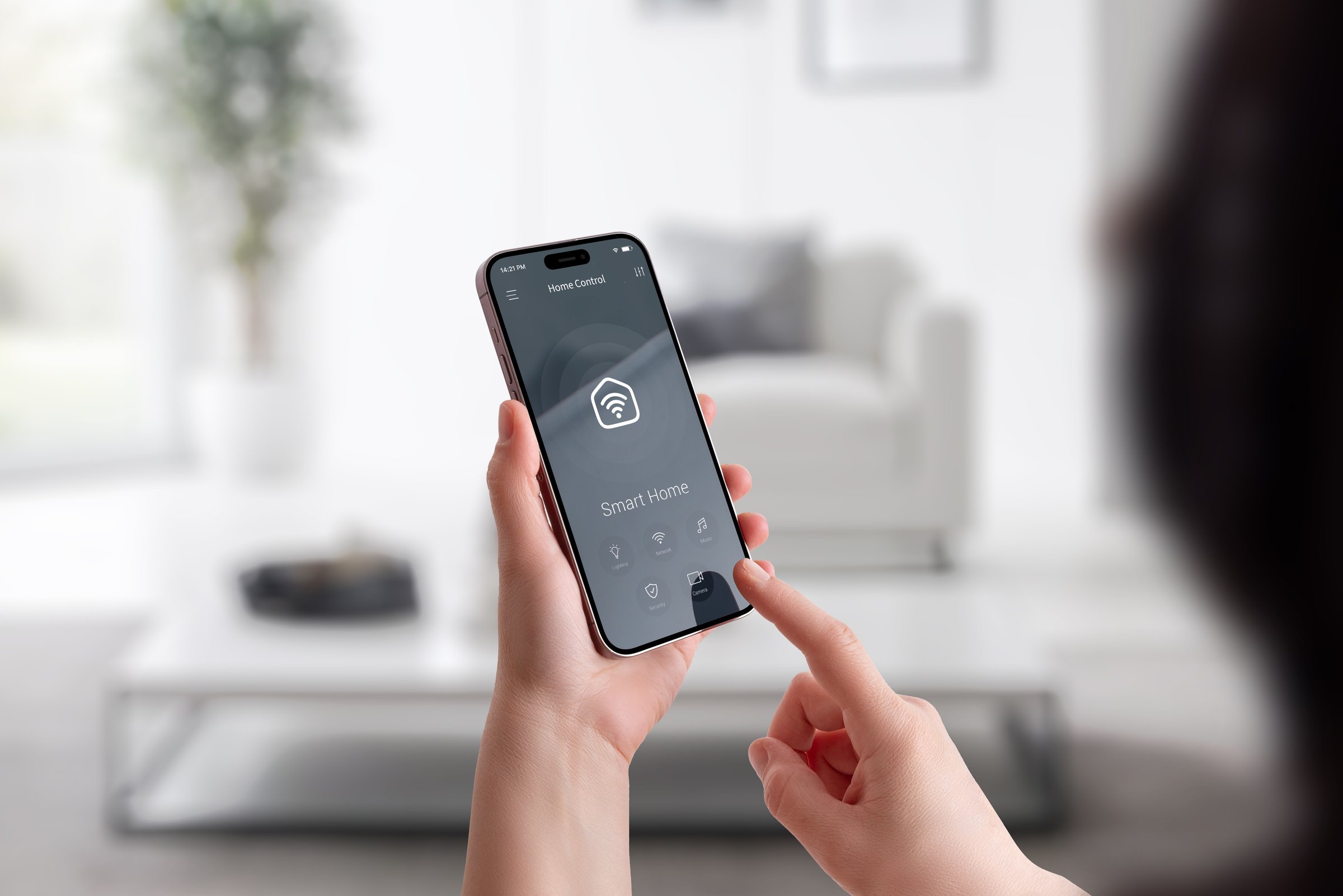 Woman interacting with smart home interface on mobile phone in modern interior environment