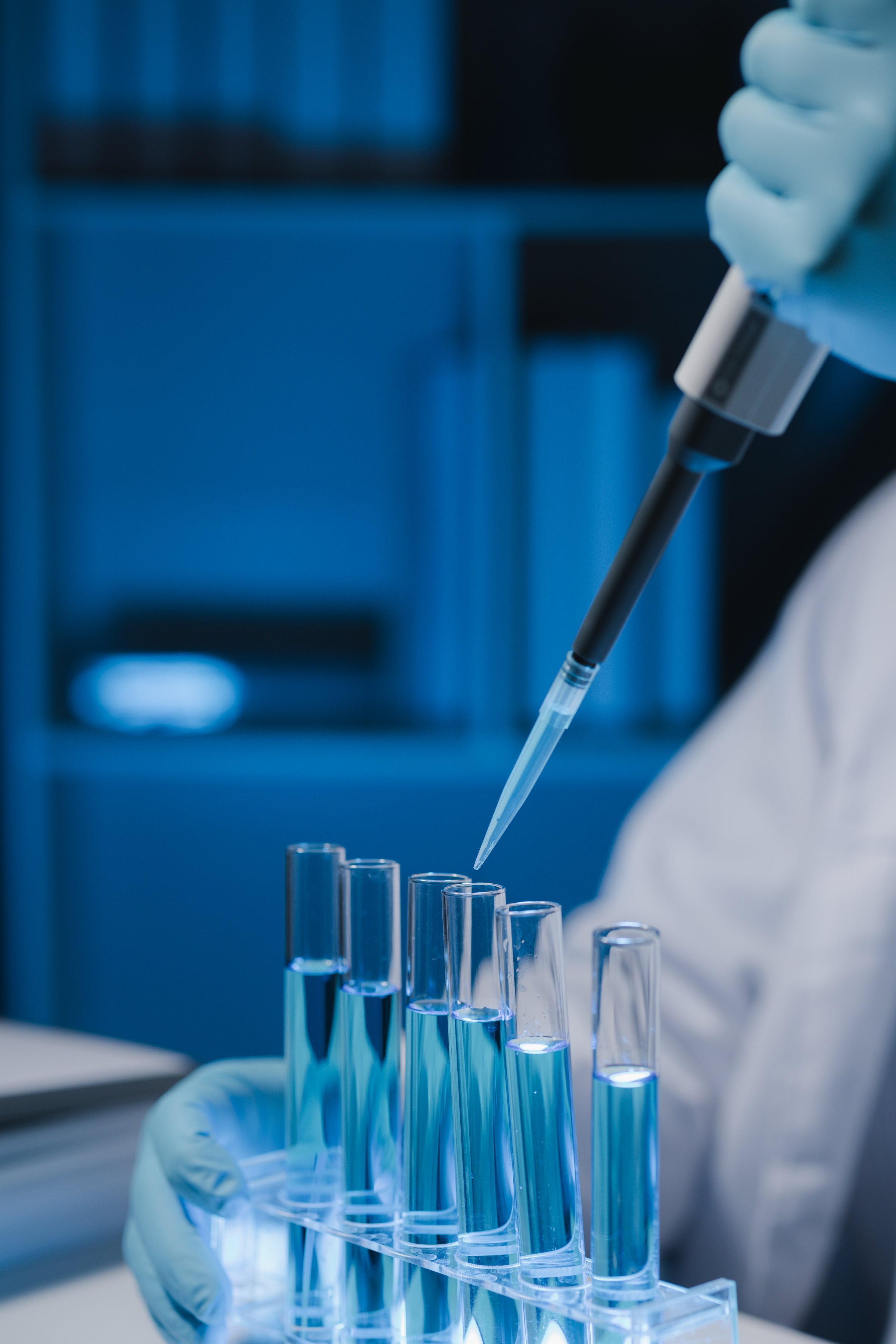 Many test tubes were analyzed by experts, A researcher is carefully studying the liquid contained in a test tube because it is an important area of research.