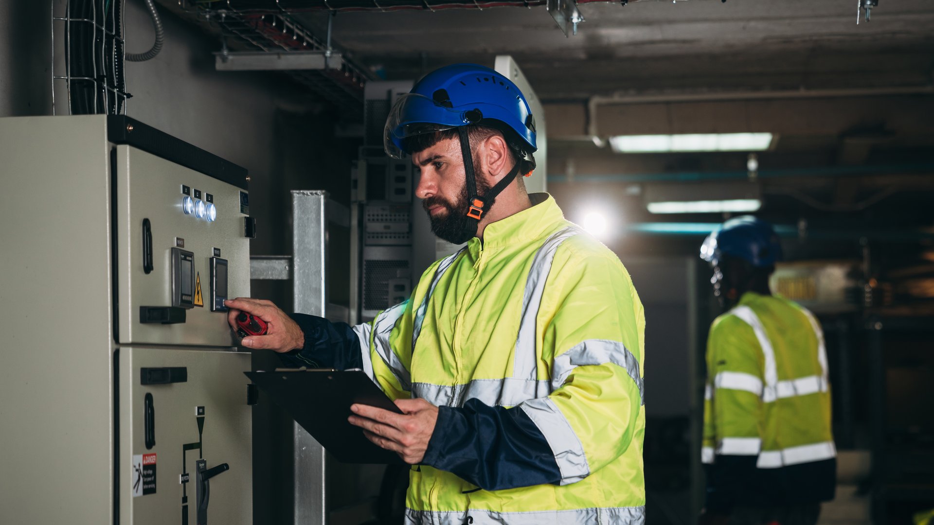Engineers inspected the electrical switchboard and verified the operational voltage range. Technician setting electrical in inverter solar panel room