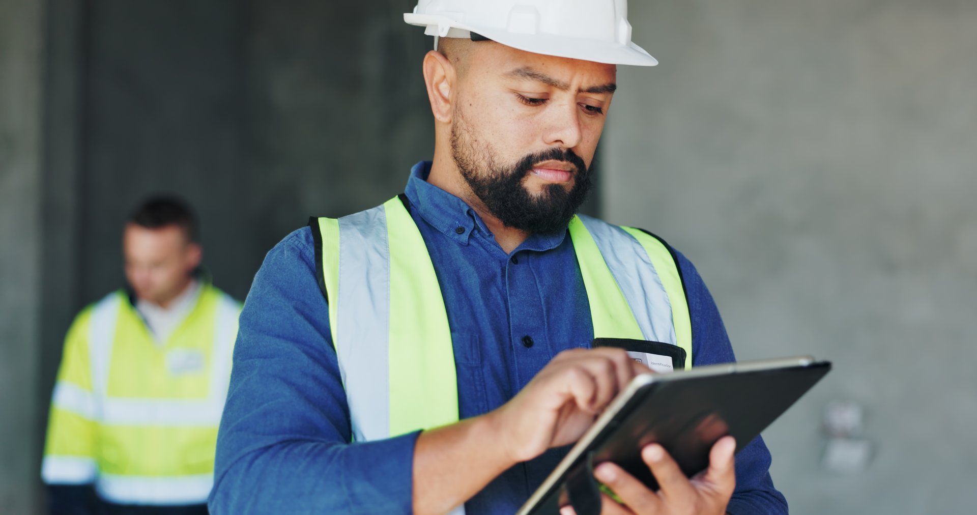 Building, serious and tablet with construction worker man on site for civil engineering or development. App, inspection and planning with developer person on location as project management supervisor