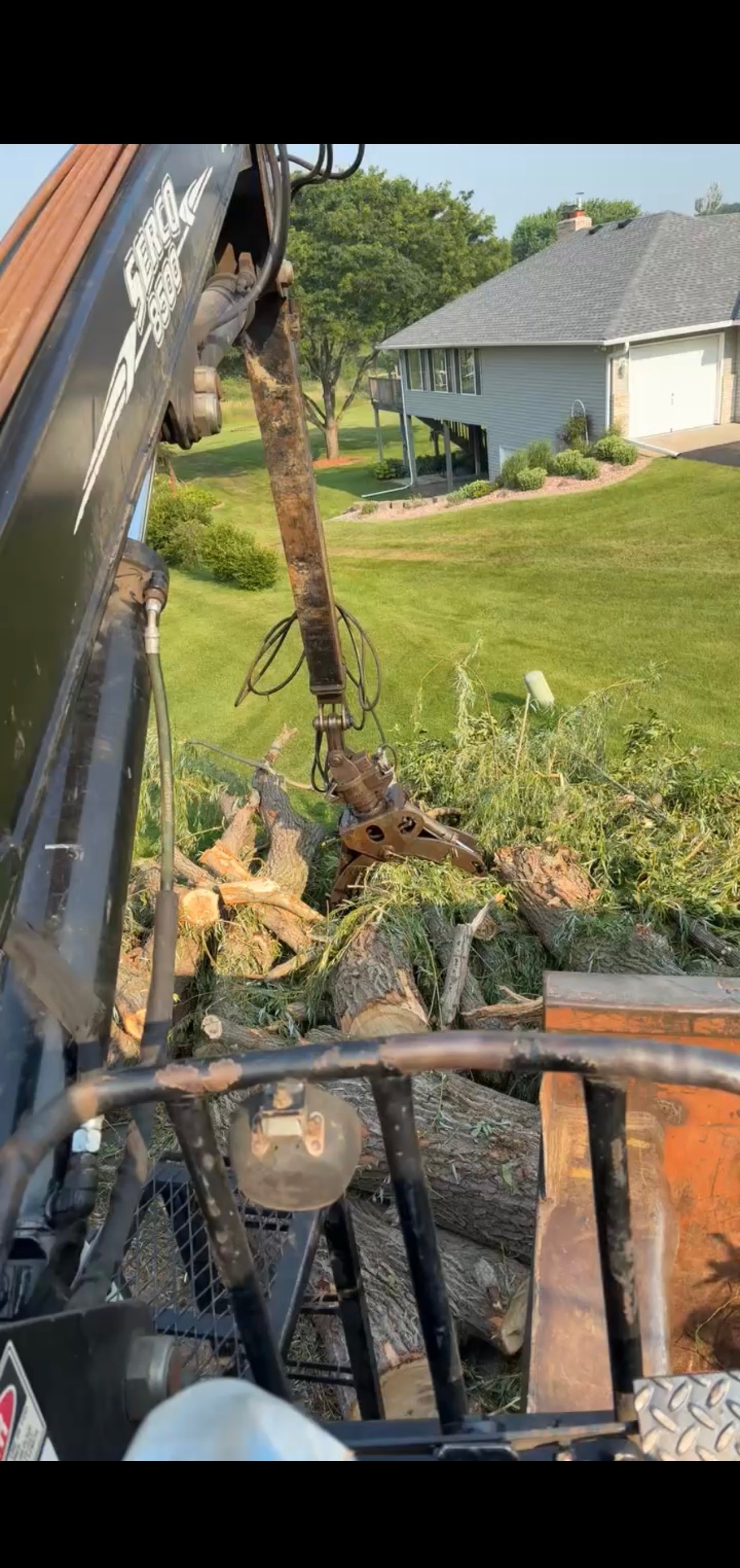 Professional grapple truck in action for tree service and debris removal