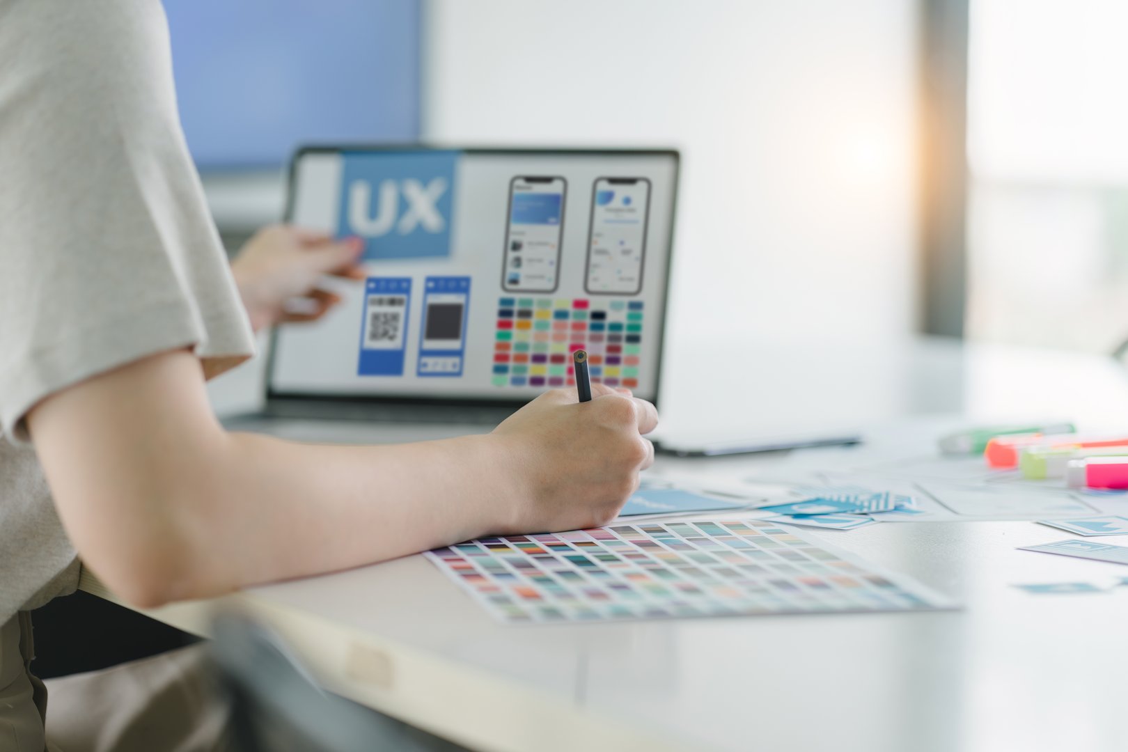 Creative ux ui designers team developing wireframe and sketching layout design mockup on smartphone screen