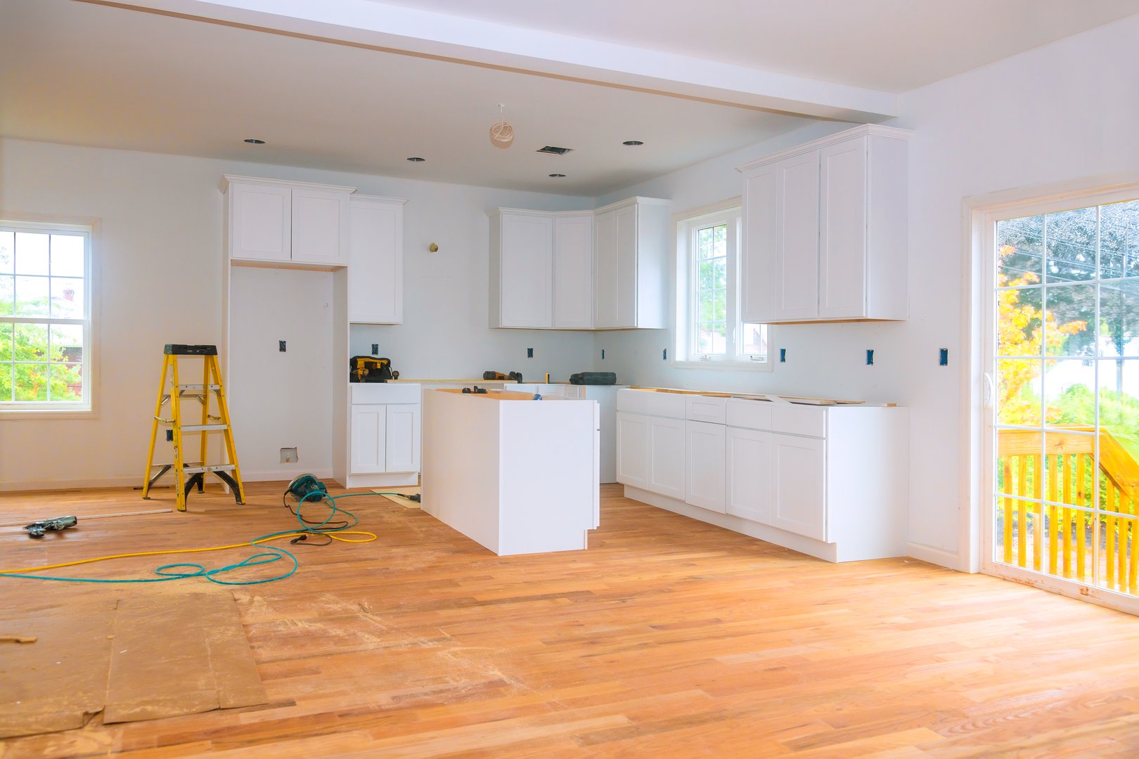 Bright airy kitchen with white cabinets hardwood flooring renovation
