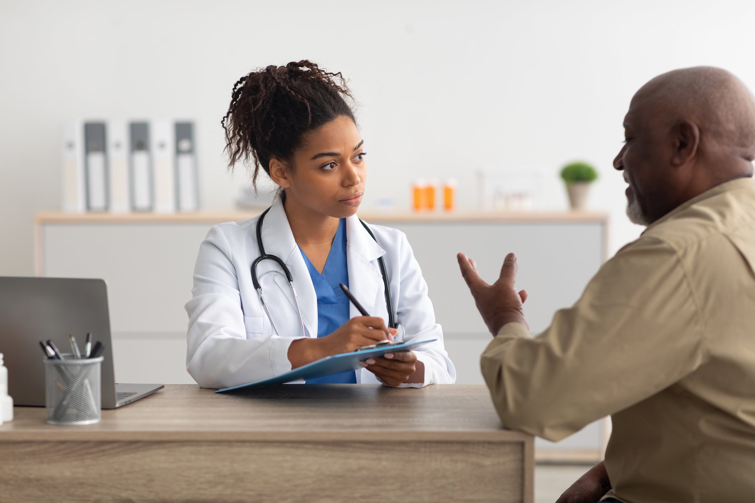 Young black doctor explaining treatment plan to patient