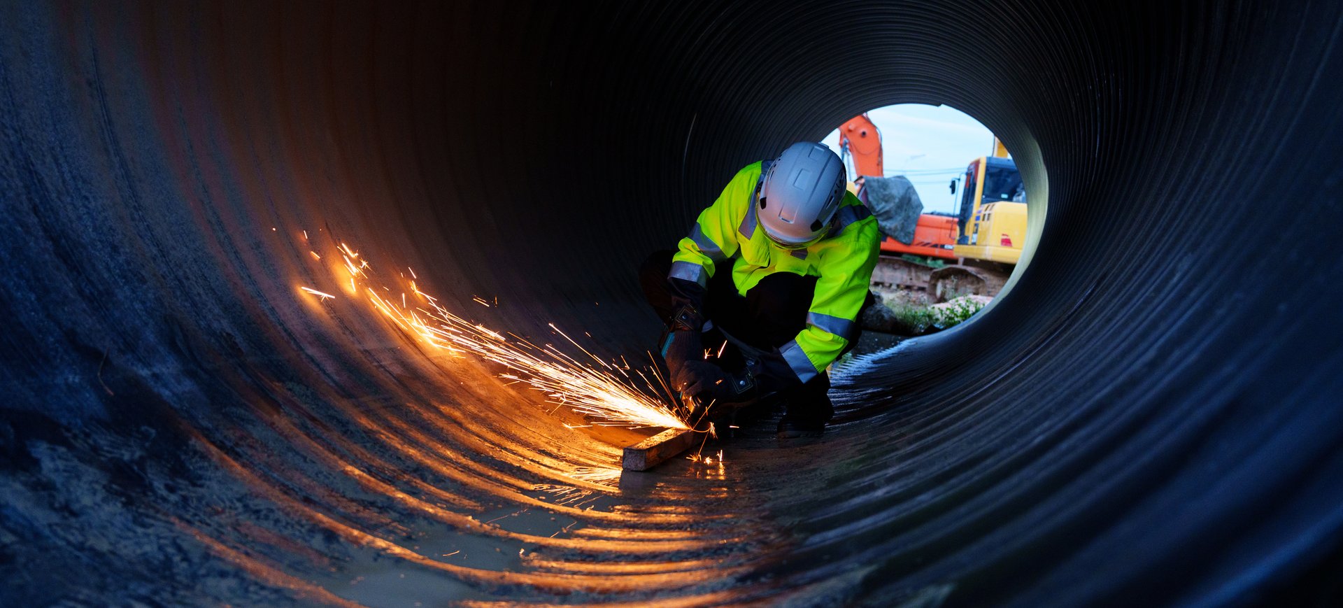 Engineers are drilling pipes for a new construction project of a large industrial building.