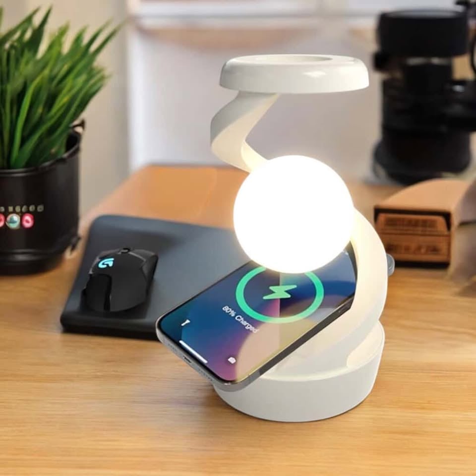 open laptop with smart watch and smartphone charging on wireless charger on beige table, Modern workplace device