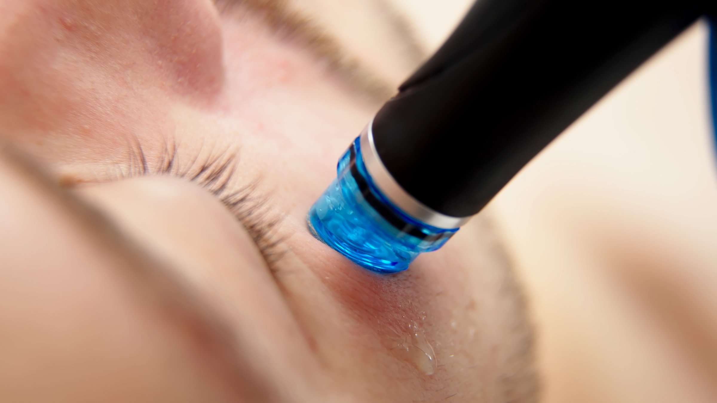 A man undergoes hydrofacial vacuum facial cleansing, rejuvenation, moisturizing facial procedure in a beauty clinic. Beauty and youth concept