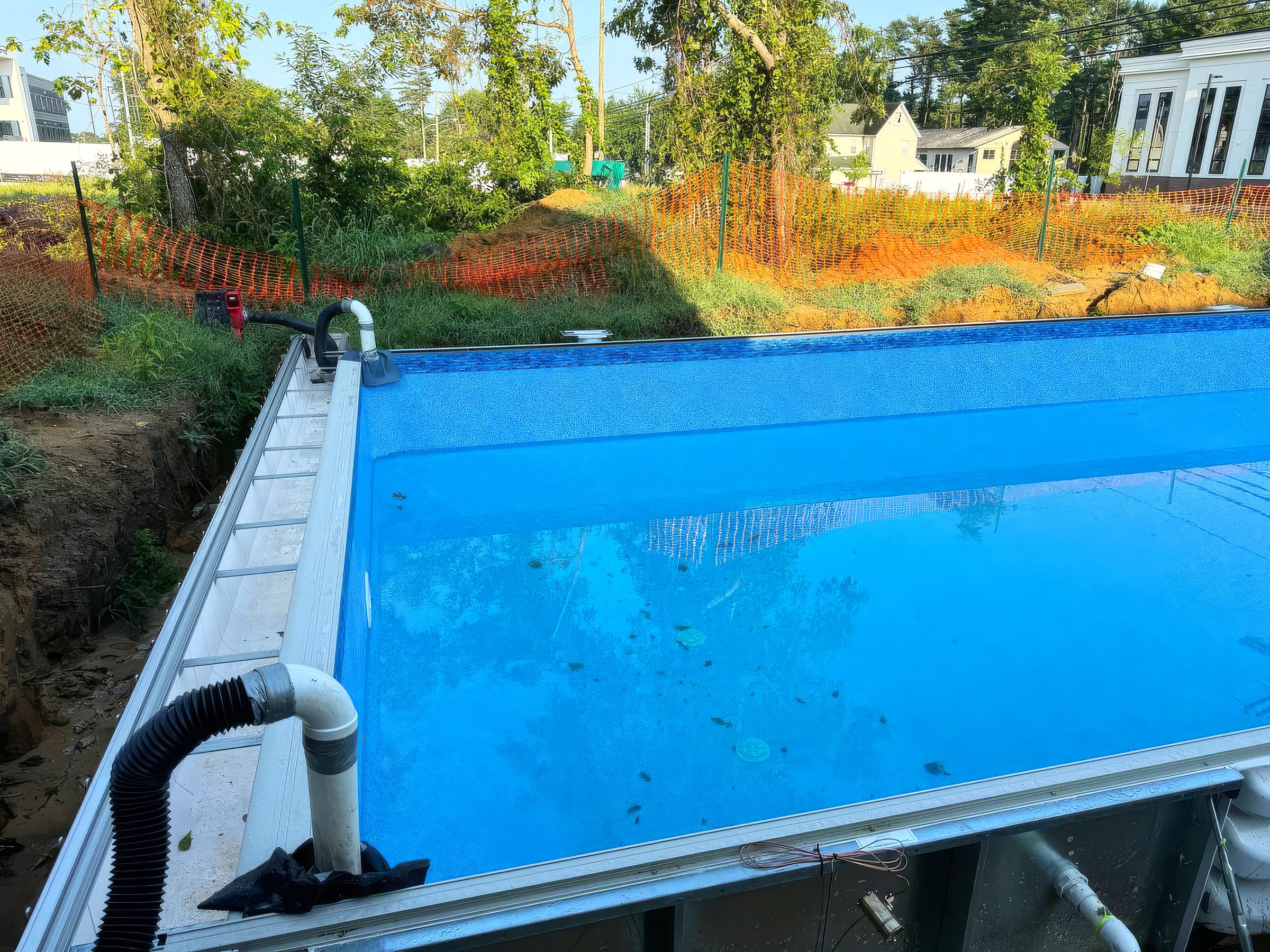Swimming ground pool construction in backyard of near house