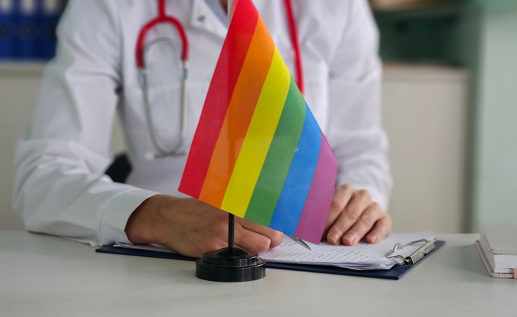Doctor with LGBT rainbow flag in clinic