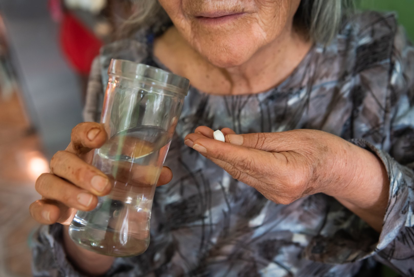 Close-up of elderly woman taking her pills. medicinal concept.
