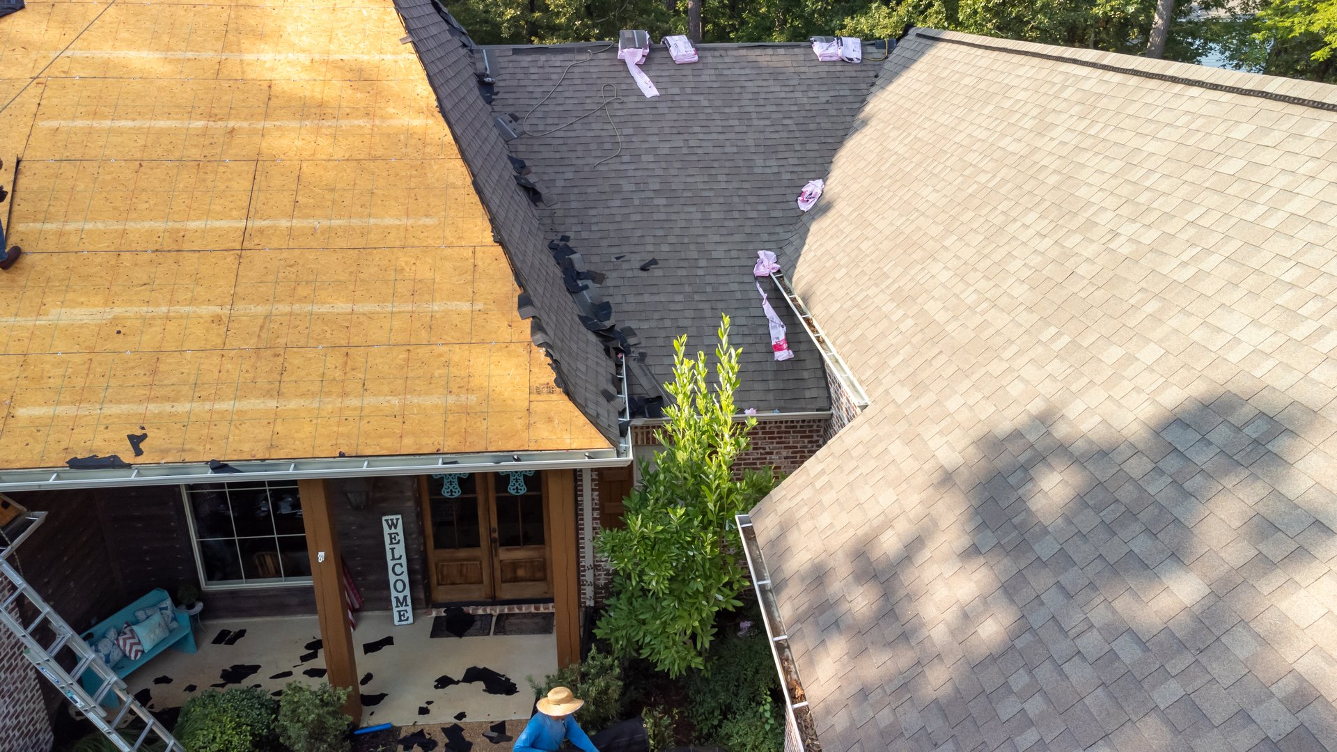 House with new roof being installed after hail damage