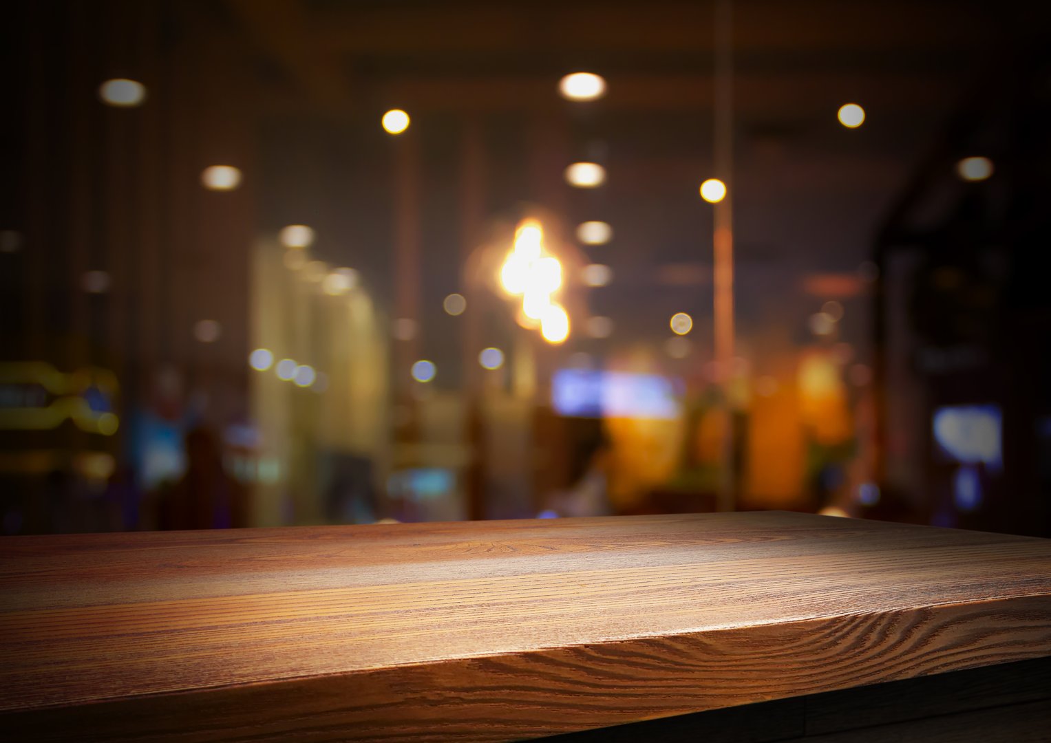 Empty wooden table with bokeh and blur restaurant background, for your photo montage or product display, Space for placing items on the table, product and food display.