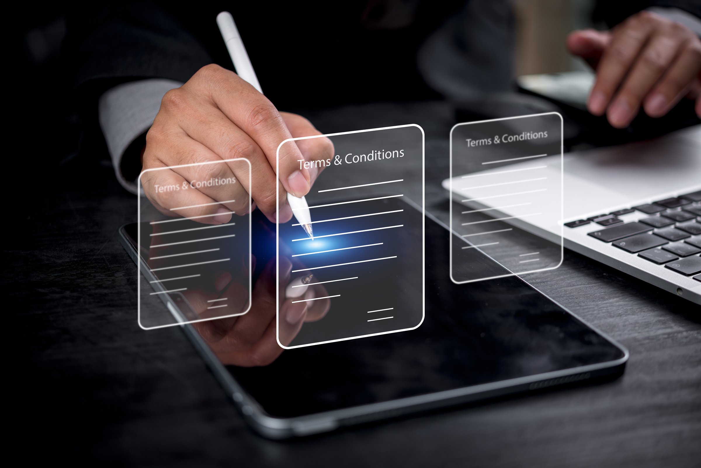 Businessman digitally signing terms and conditions on a tablet, with holographic icons representing legal documents, contracts, and e-signatures, showcasing modern document signing.