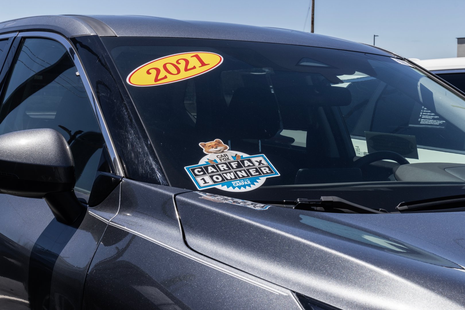 Indianapolis - June 30, 2024: Carfax sticker on a used pre-owned vehicle. Carfax provides vehicle reports for prospective buyers that may reveal problems.