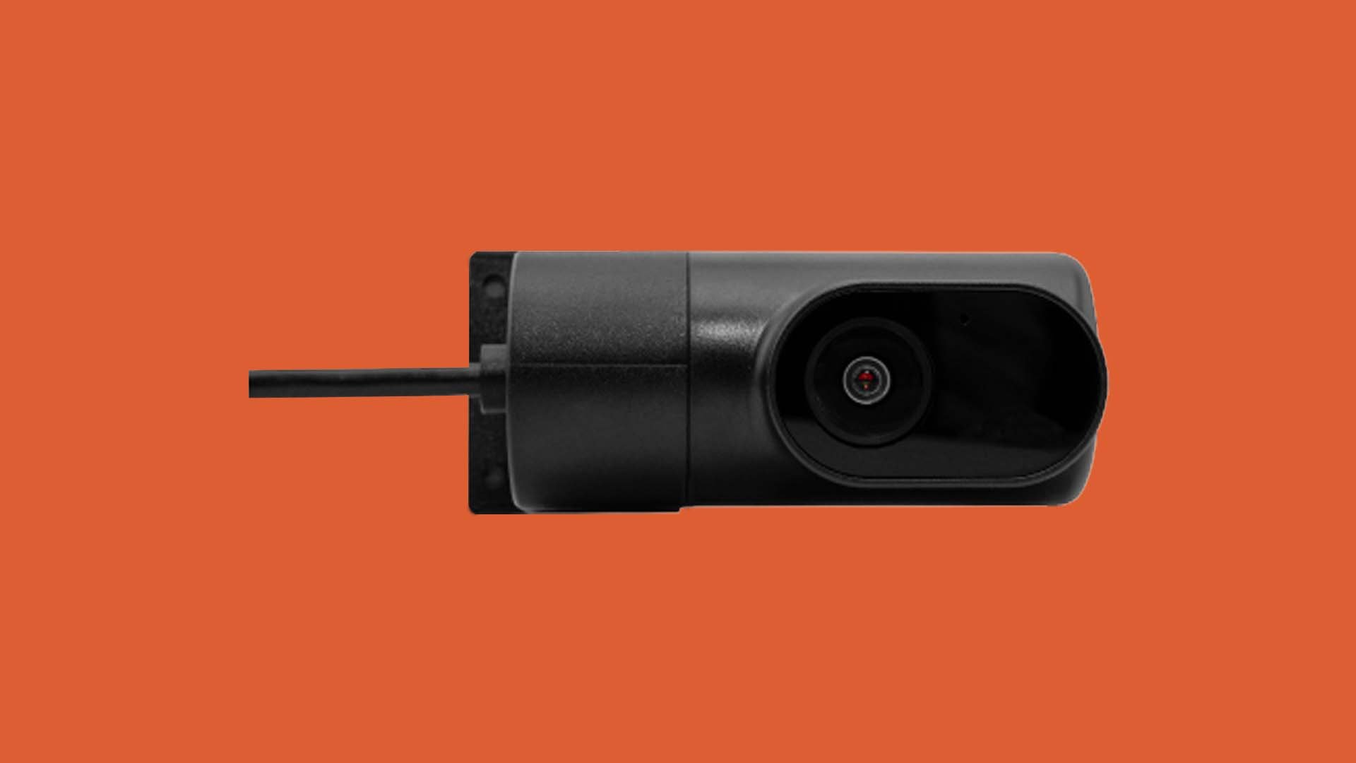 A small black electronic device with a mounting bracket against an orange background.