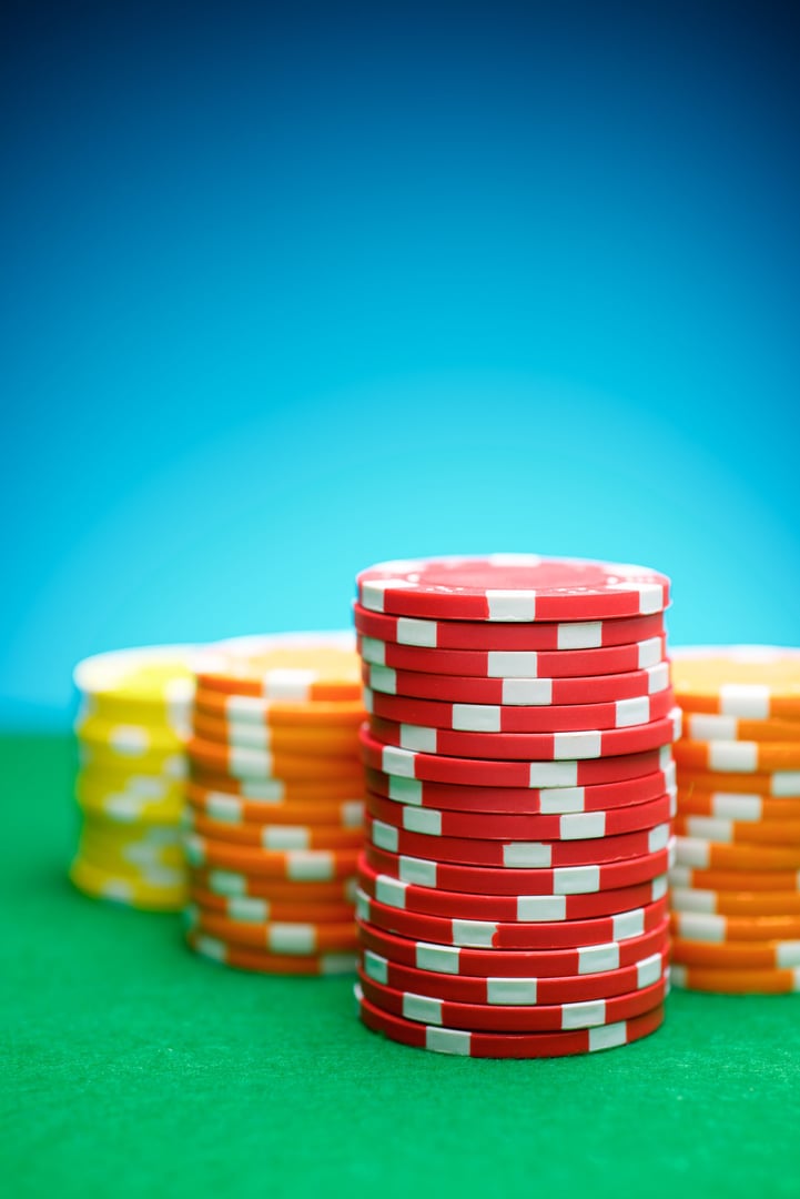 Close-up of a group of casino chips on a green mat