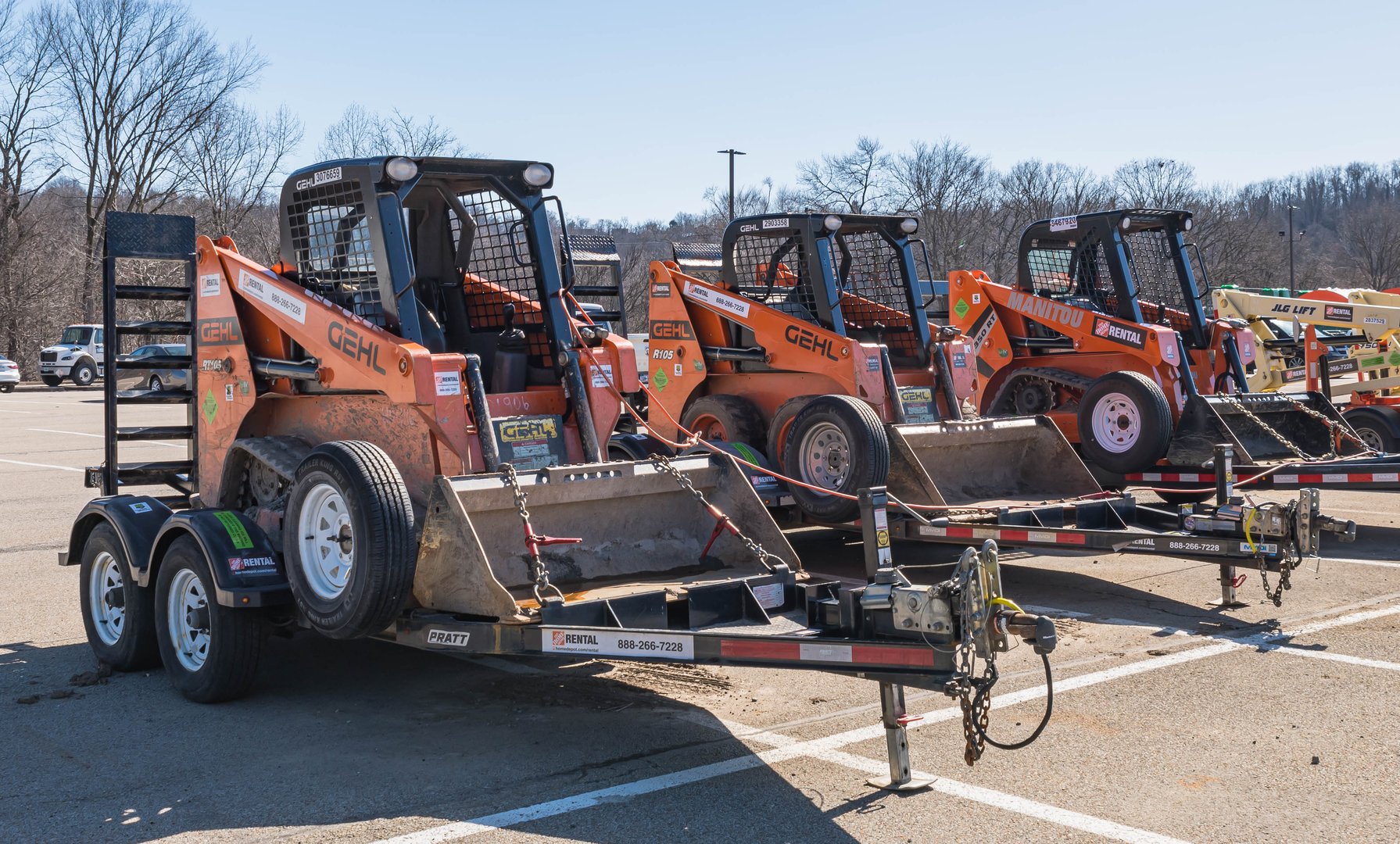 Wilkins Township, Pennsylvania, USA February 25, 2024 Heavy construction machinery available for rent in the parking lot of Home Depot on a sunny winter day