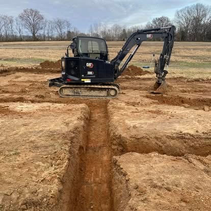Blair Excavation excavator and dump truck working on excavation project