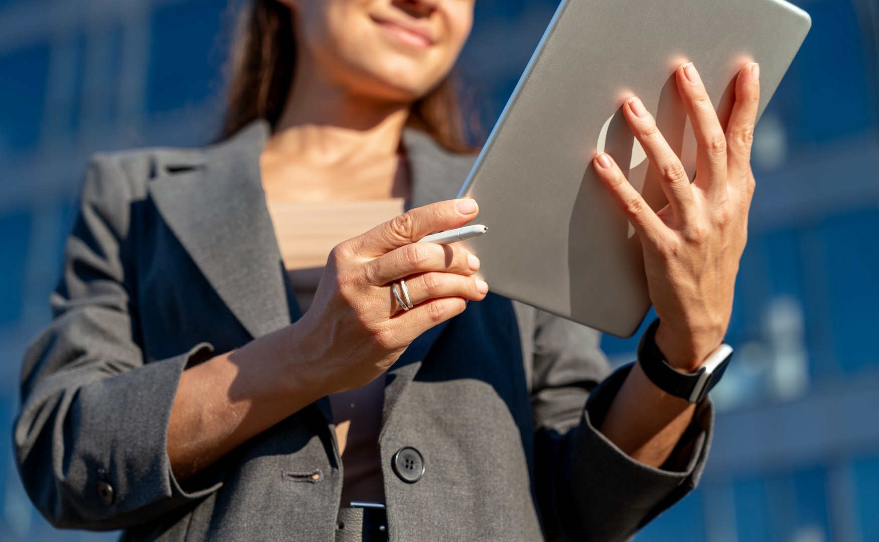 Closeup digital stylus pen and digital tablet in hands of businesswoman.