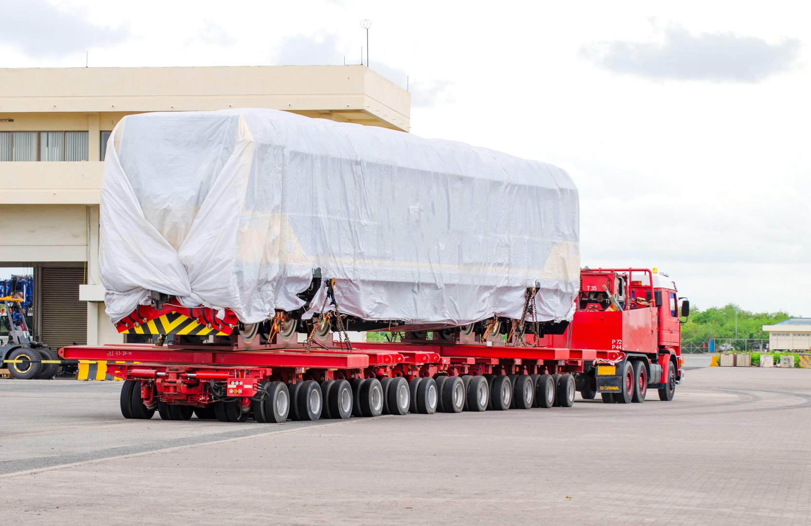 Transport of Oversize Heavy Machinery cargo truck Loading a new locomotive port area