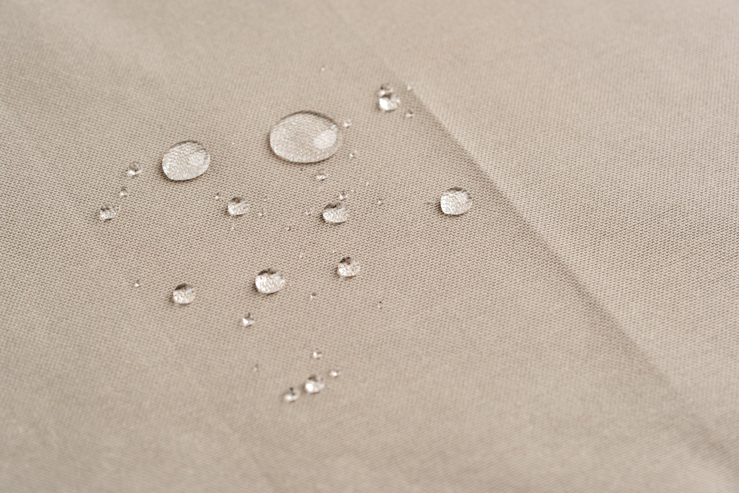 Water Droplets on Beige Fabric Surface Close Up Photo
