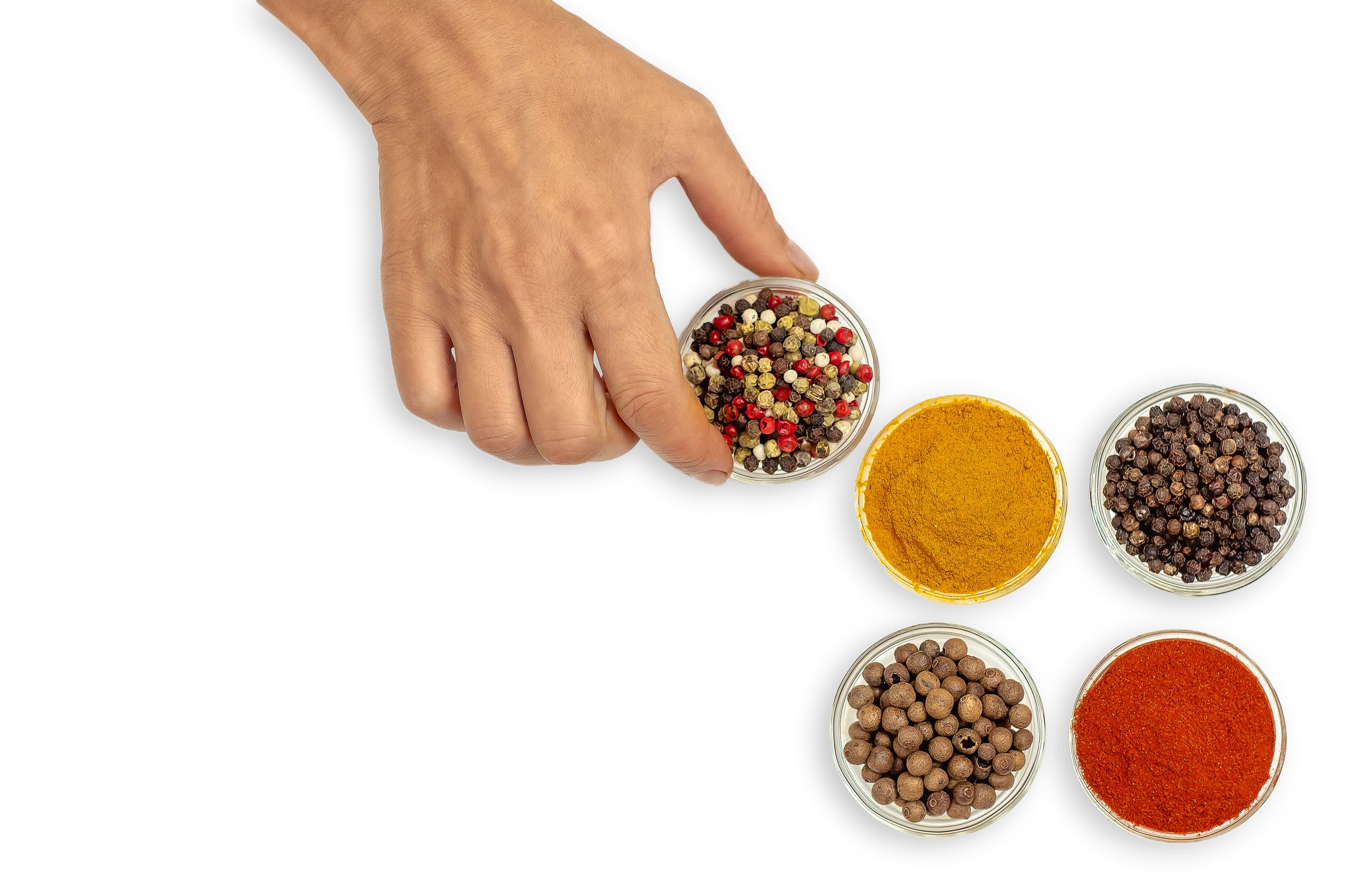 Female hand puts bowl of spices on table