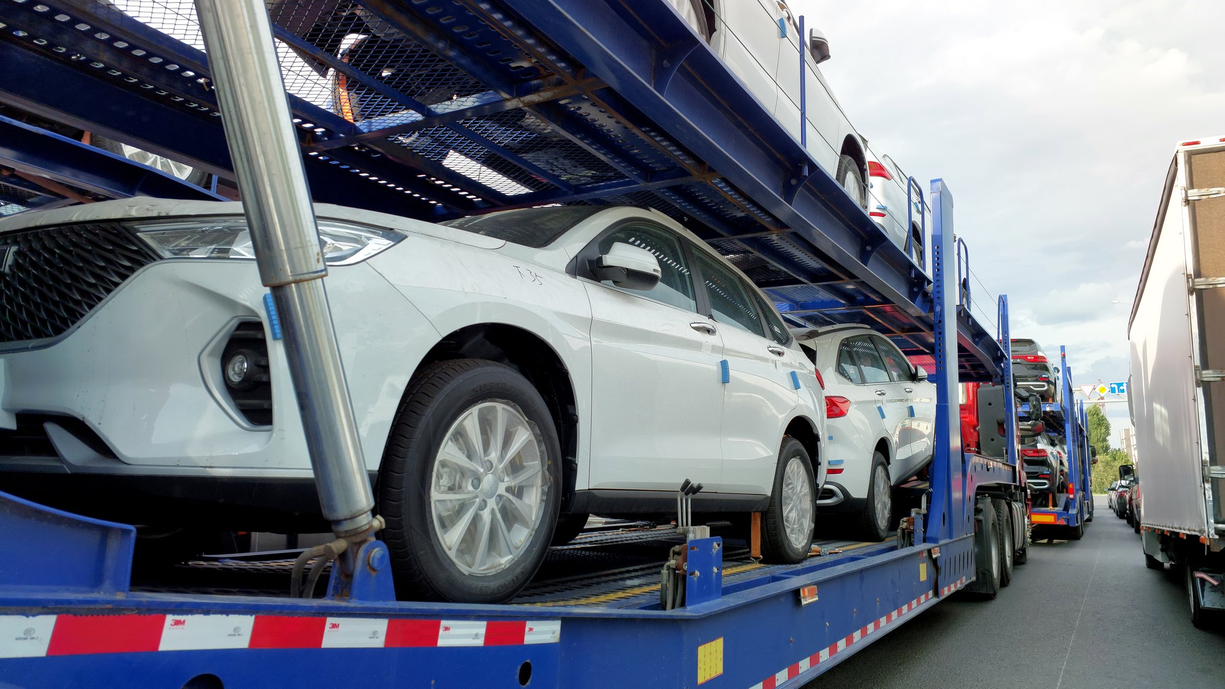 Uralsk, Oral, Kazakhstan (Qazaqstan), 10.07.2024: Car transporters loaded with Chinese cars. Car transporters transport new cars