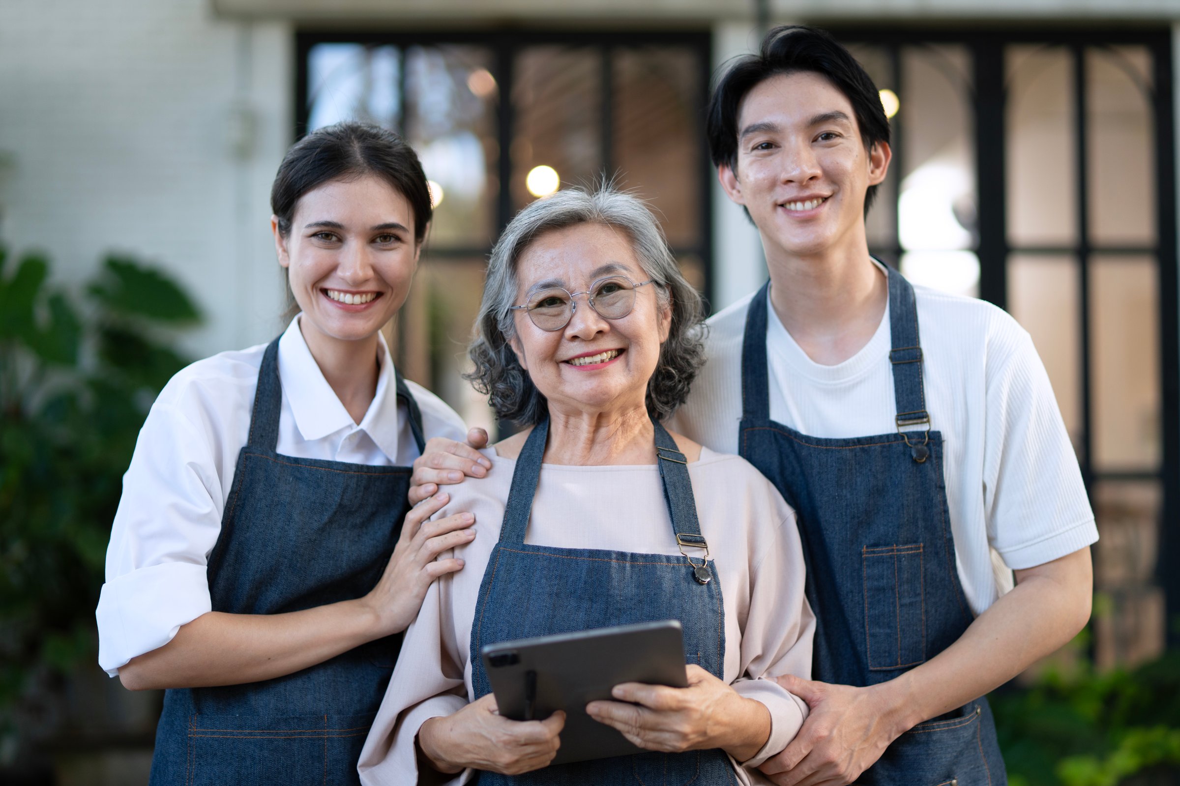 Mother, son and daughter are working at their DIY store. Small business, family business.