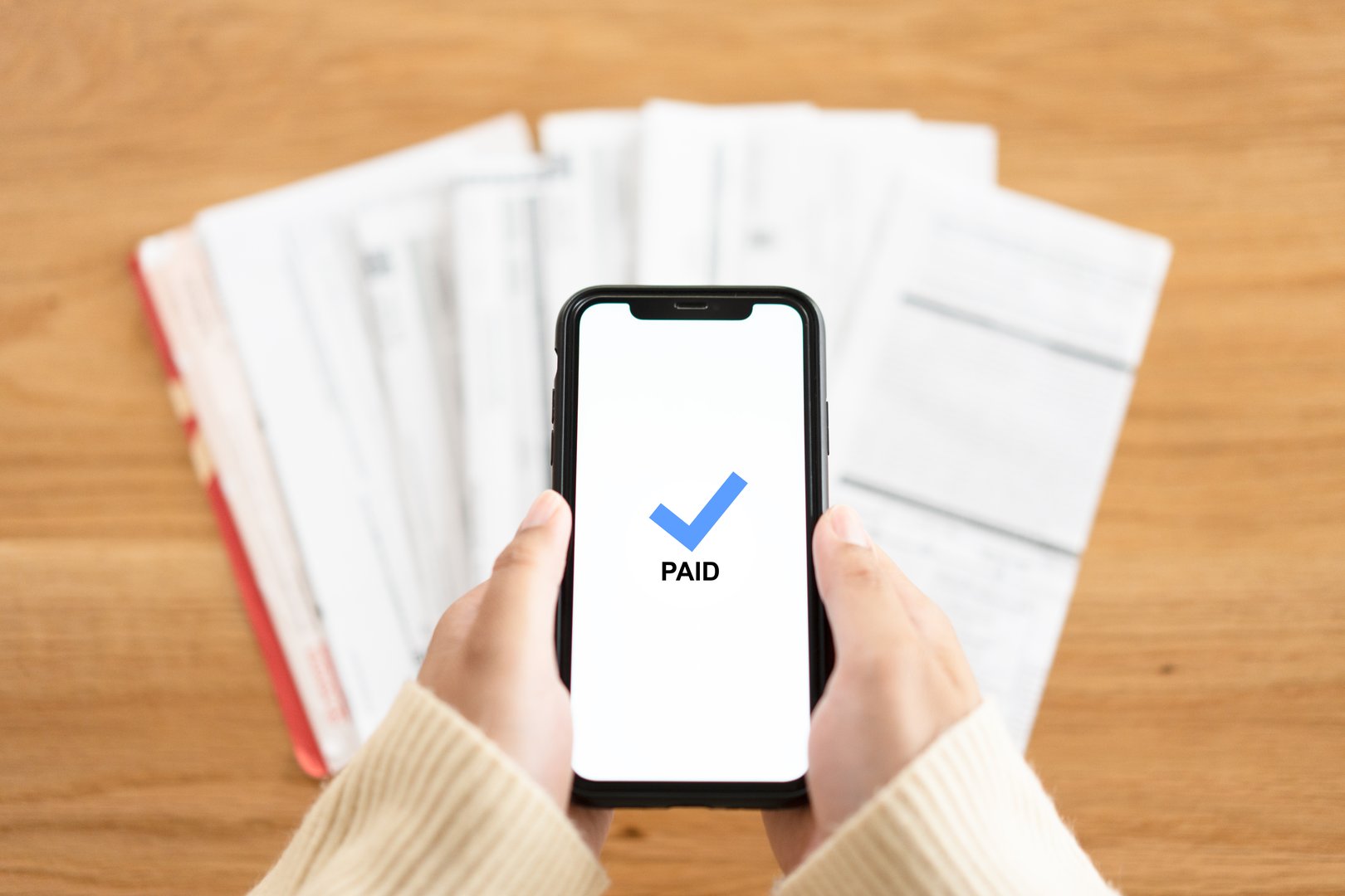Woman hands with bill payment online using mobile phone success and get paid.