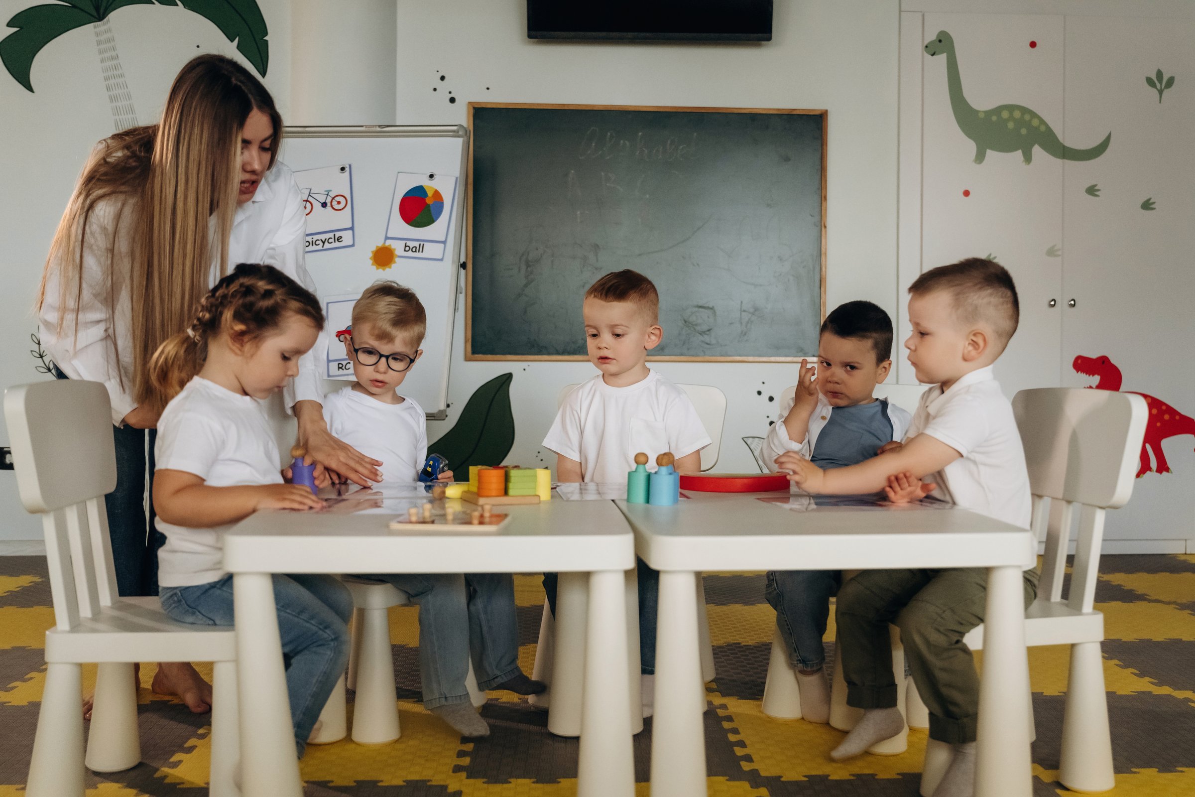Educational games. Children in kindergarten with their teacher.