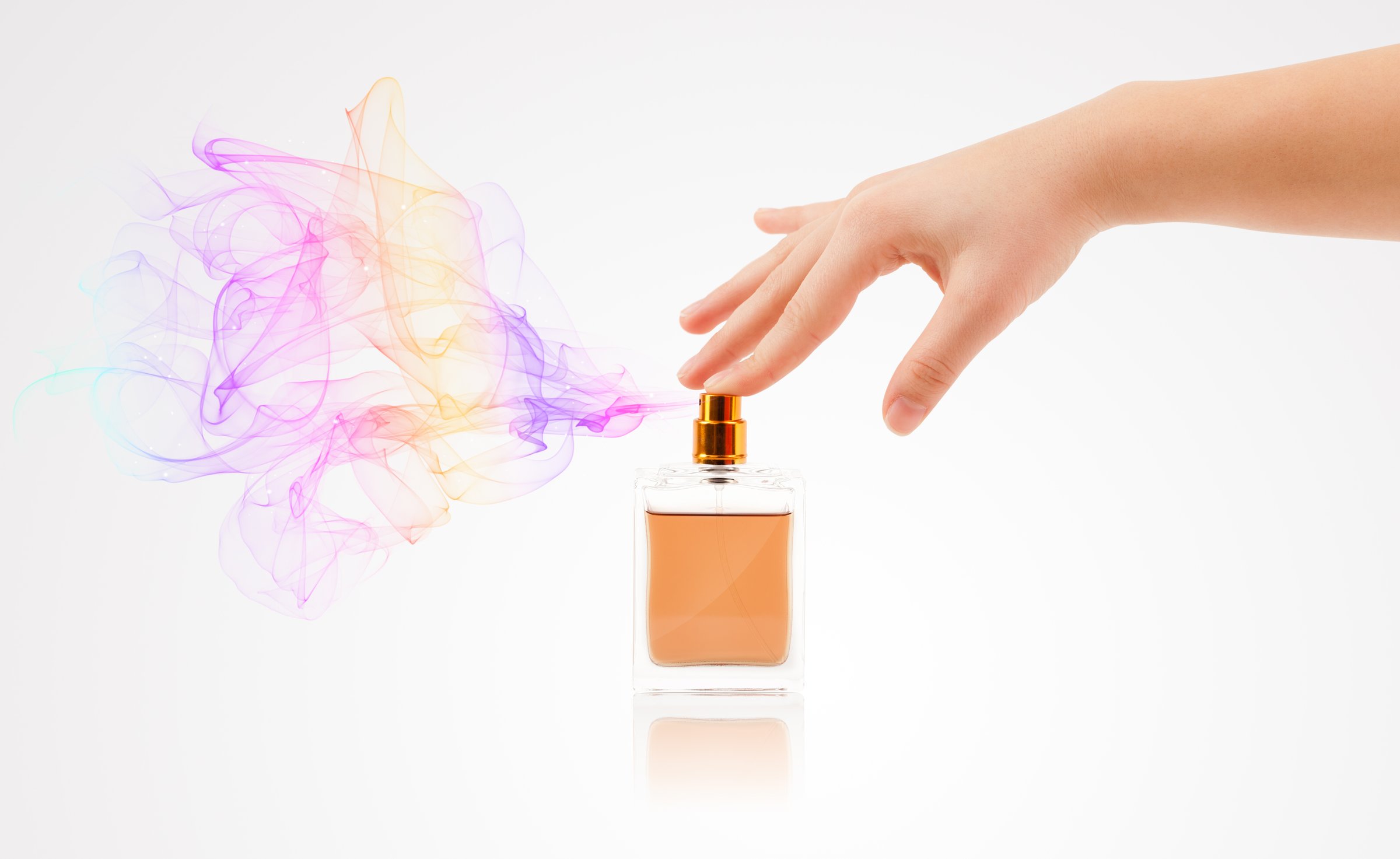 close up of woman hands spraying perfume
