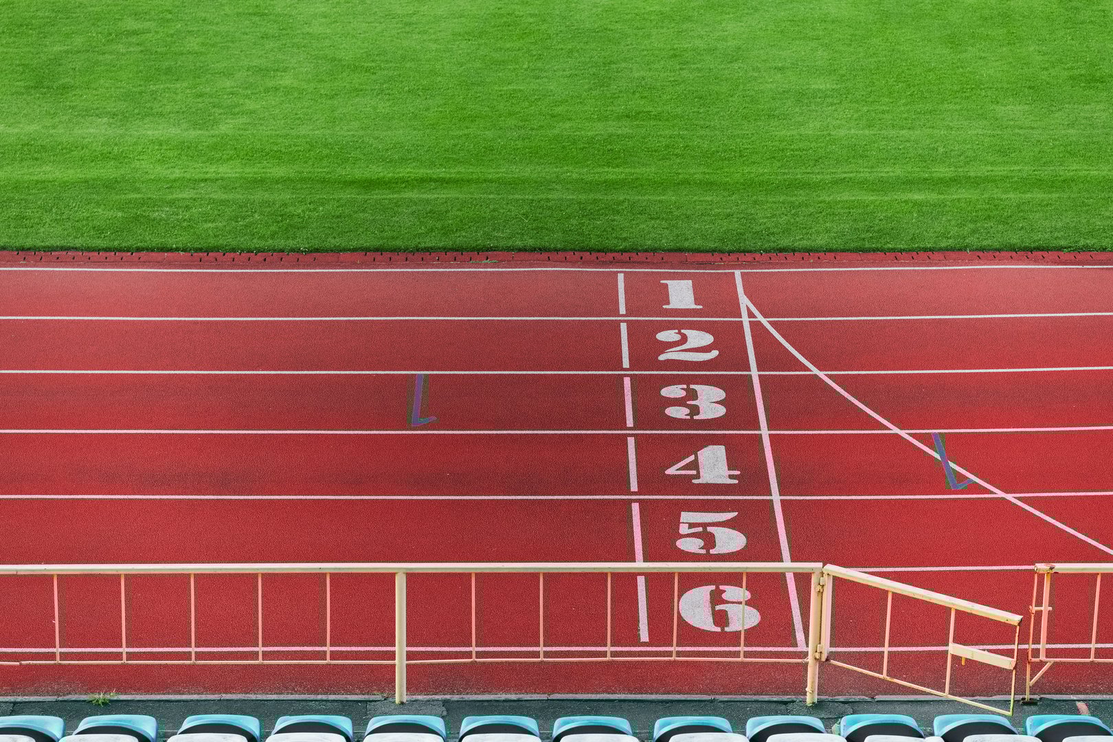 sport complex arena top view running track and green grass of soccer field empty background wallpaper concept